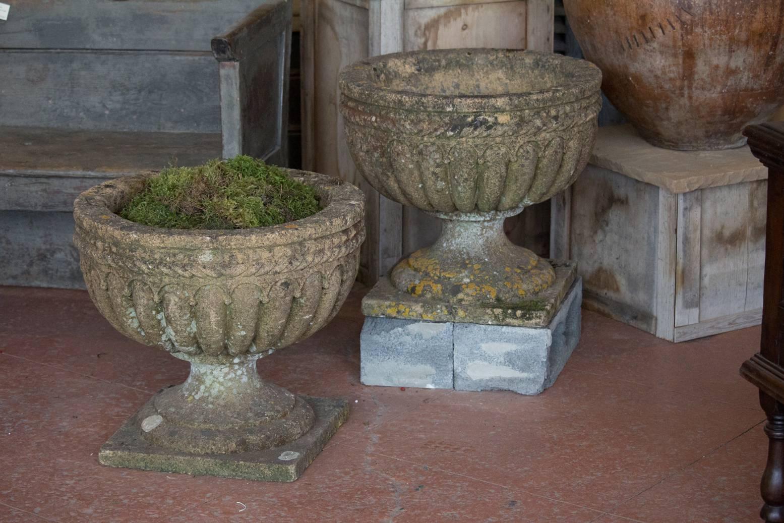 Pair of large English antique classical stone urns with Gothic design. Wonderful patina.