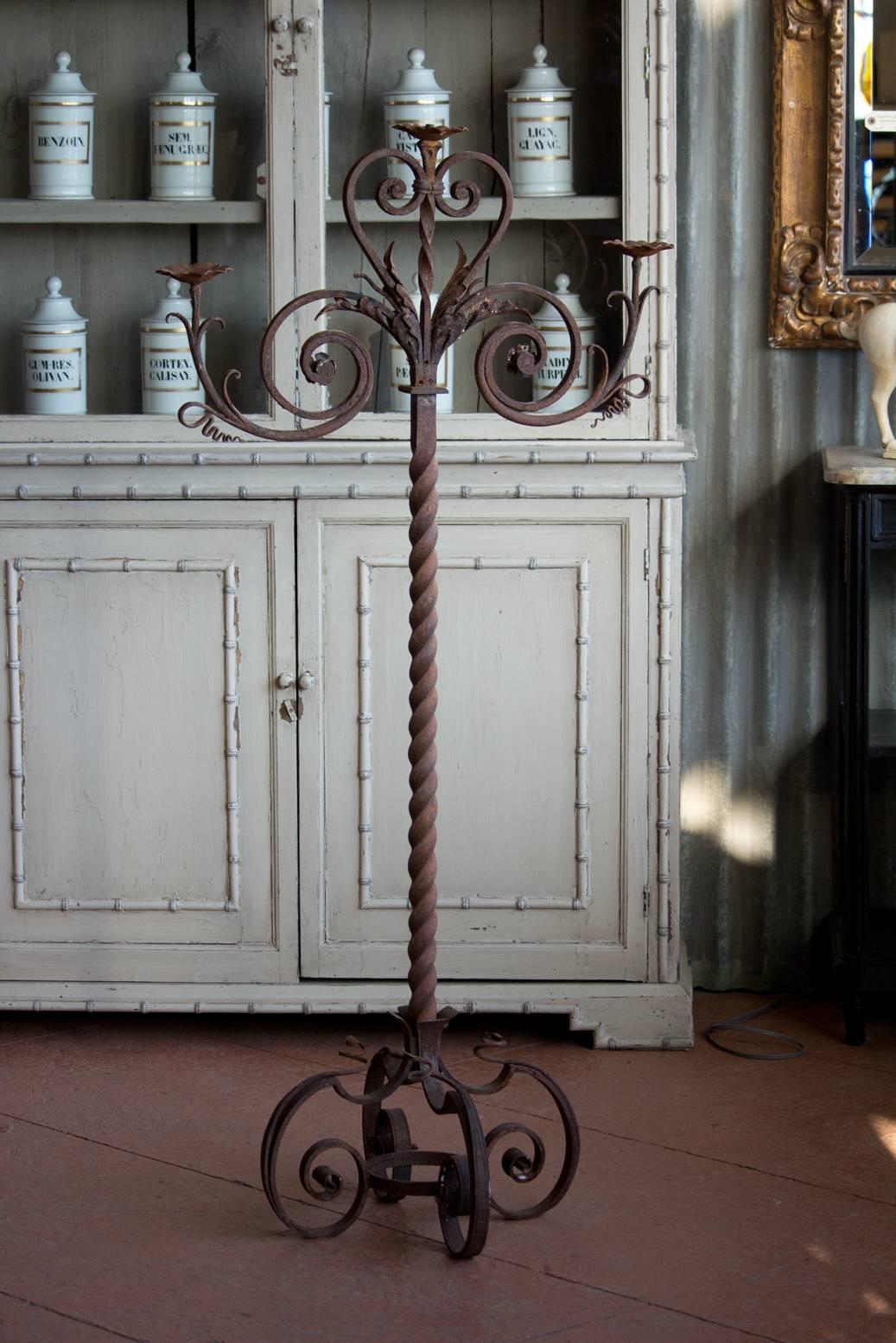 19th century French floor standing wrought iron candelabra with beautiful scroll work and patina.