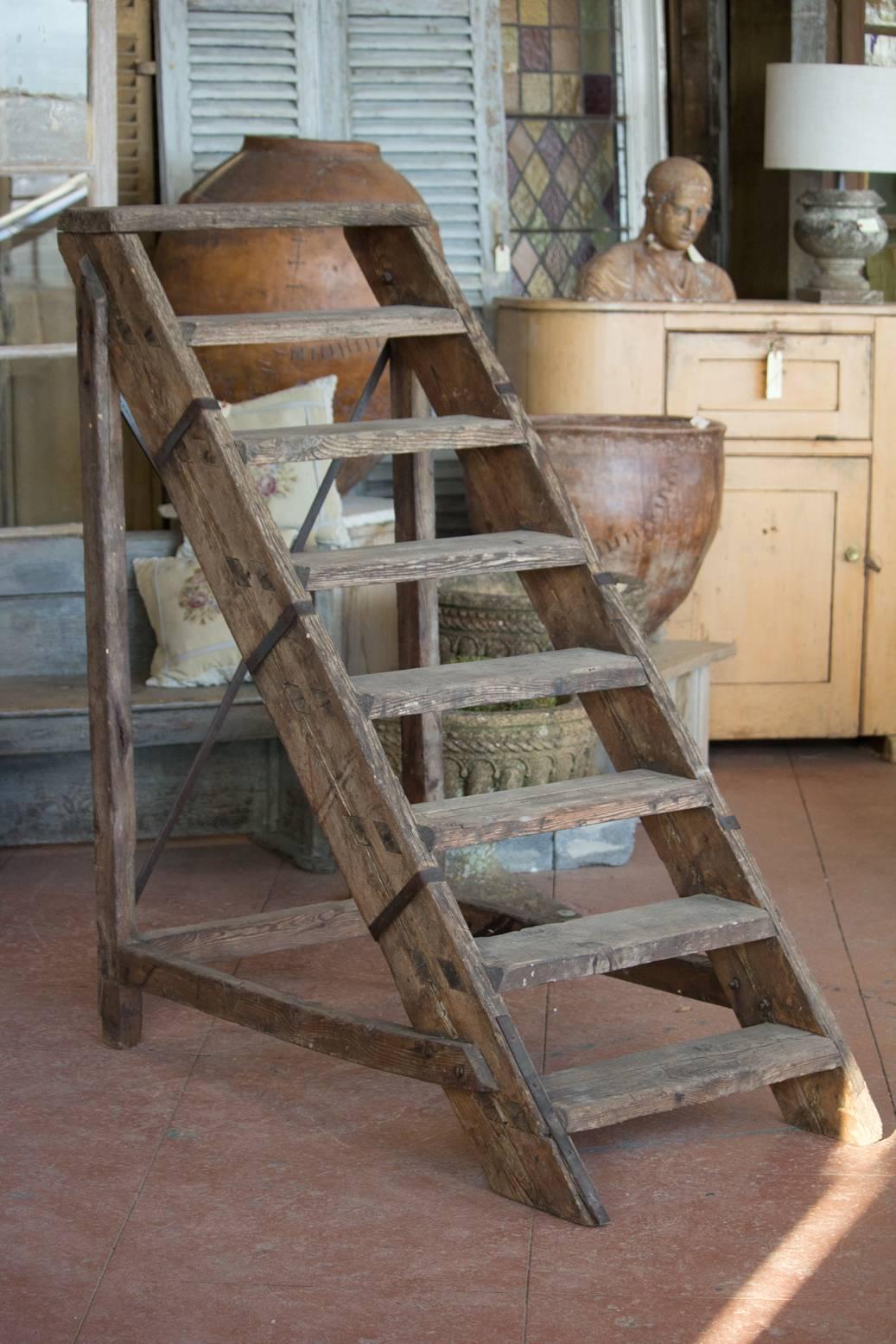 Rare wooden set of antique French Industrial stairs with X-shape iron strapping to the back.