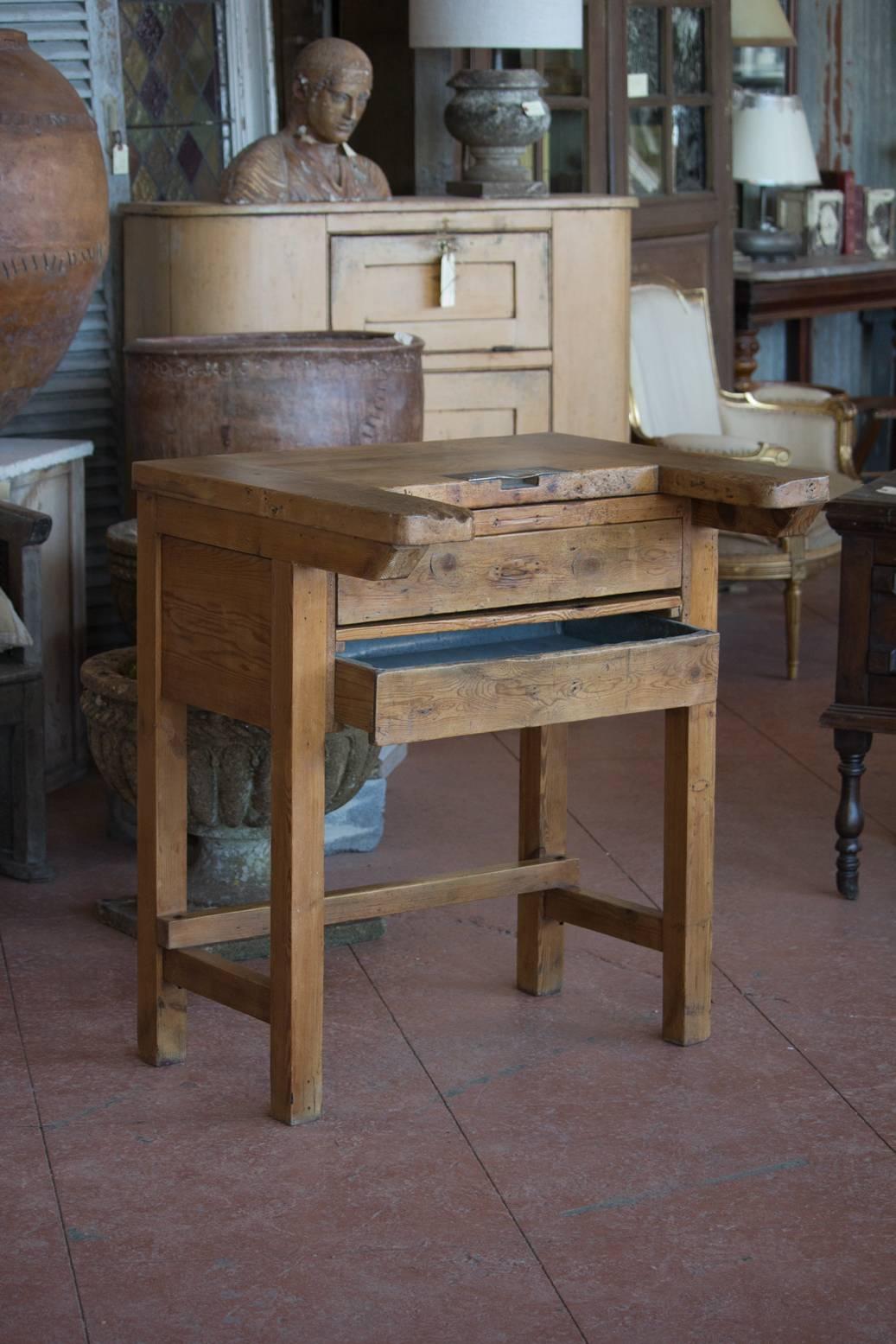 Rare antique English watchmakers desk. It has an unusual shape top for arm rests, drawer, pull-out shelf and a zinc lined drawer to catch the bits!
