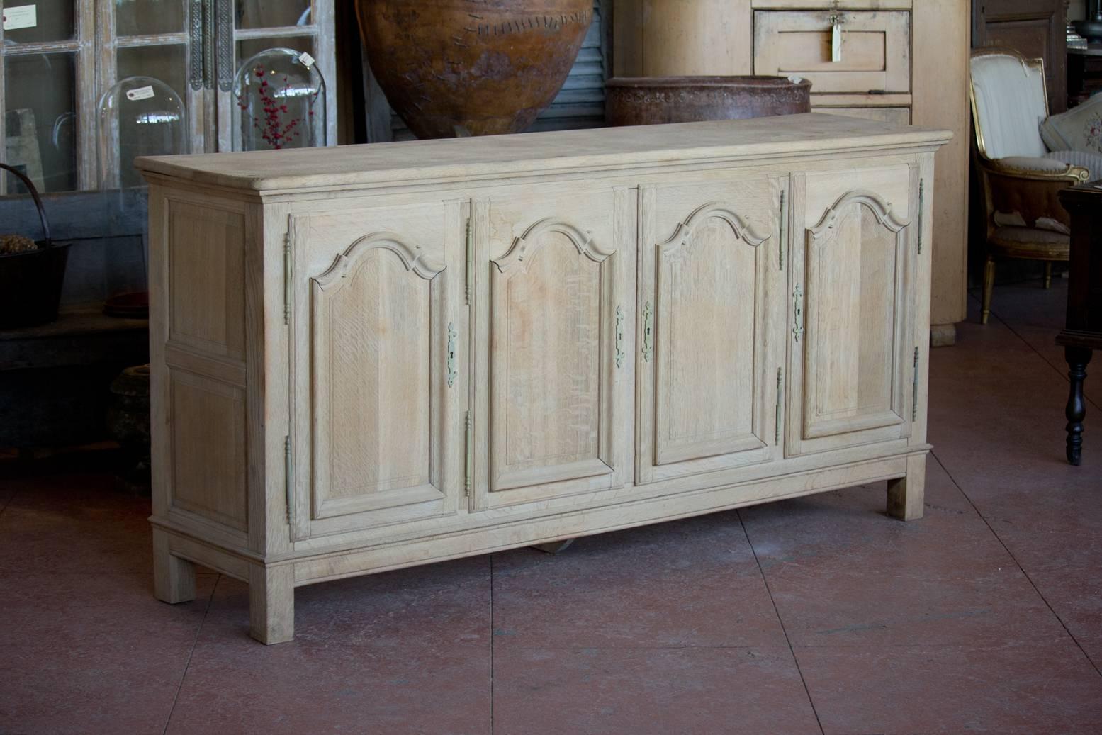 Vintage French, Louis XVI revival stripped oak enfilade with four paneled front doors and sides, There are four drawers behind one cupboard door and the shelving behind the others.