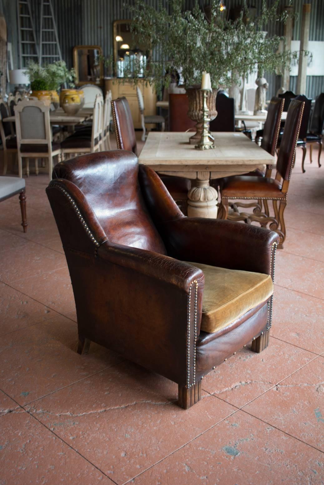 French moderne leather club chair with caramel velvet cushion. The leather has a superb rich color and patina.