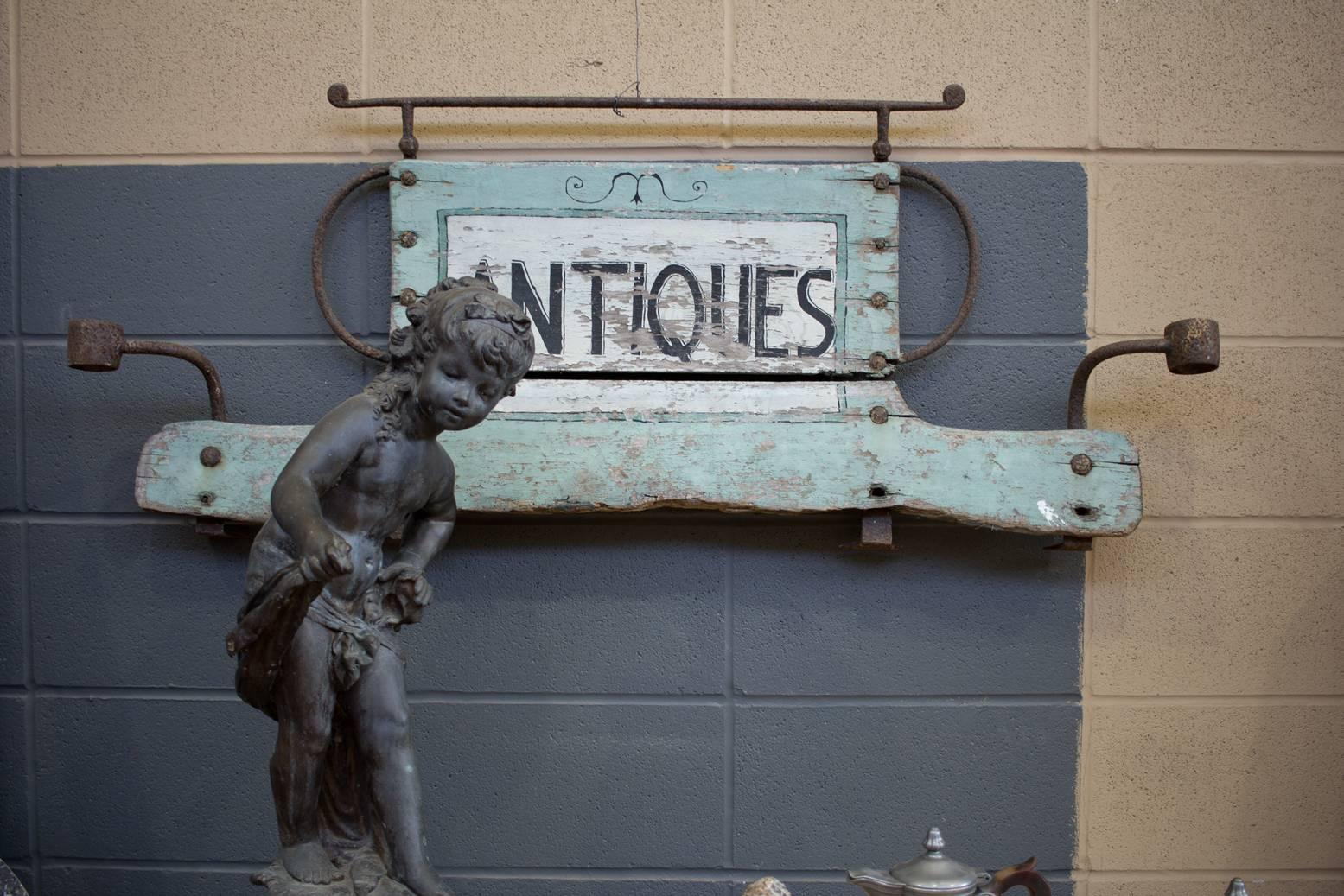 Folksy mercantile English antique sign in wrought iron frame with its original paint.