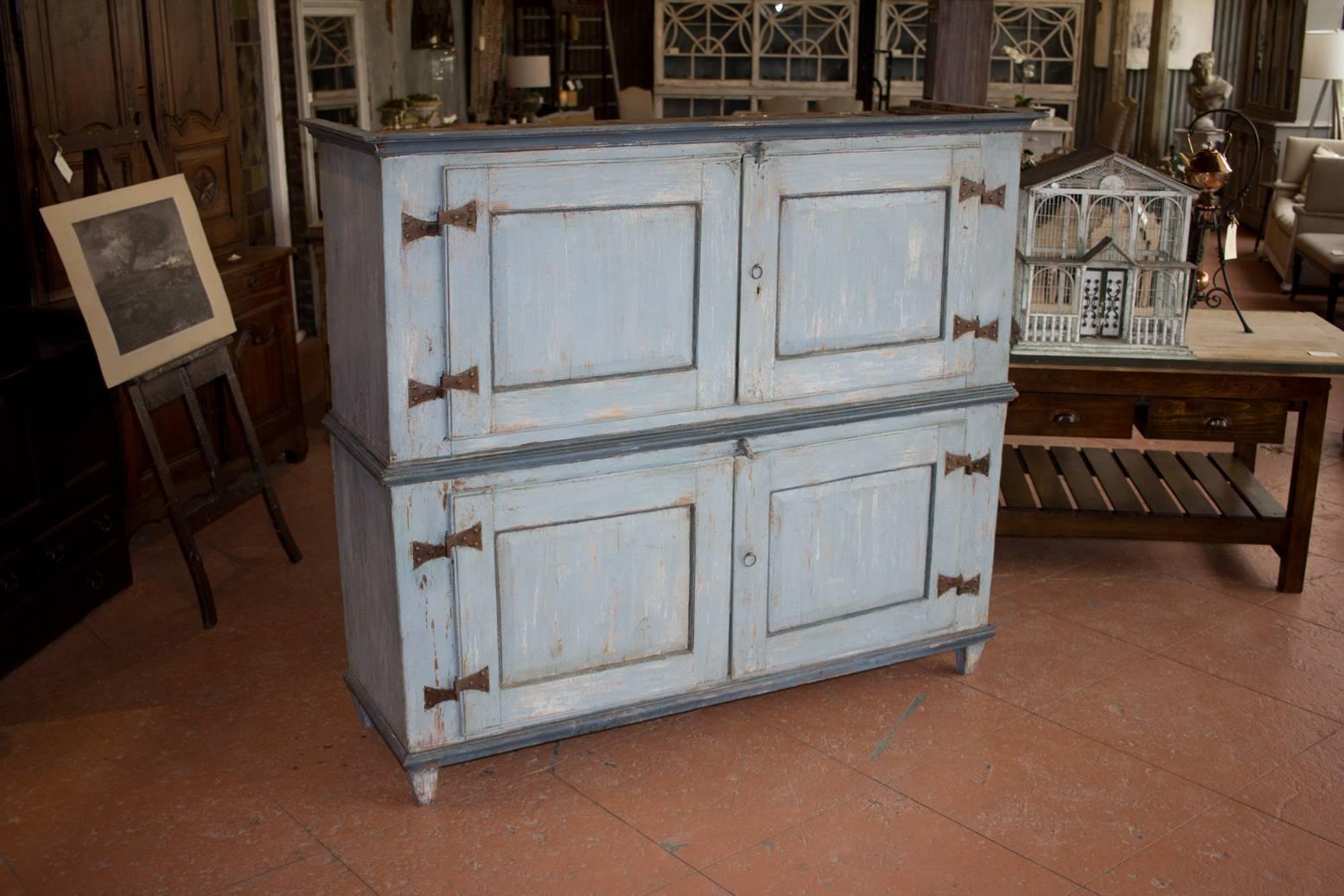 Rare circa early 1800s Gustavian four-door cupboard with butterfly hinges and its original blue paint. Inside has a beautiful rich terracotta paint color.