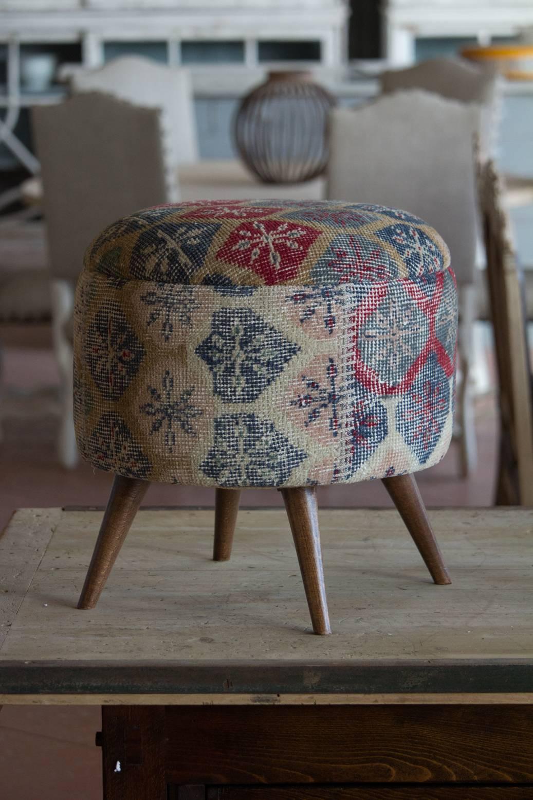 Small handmade ottoman/pouf upholstered in vintage hand-knotted Turkish carpet.