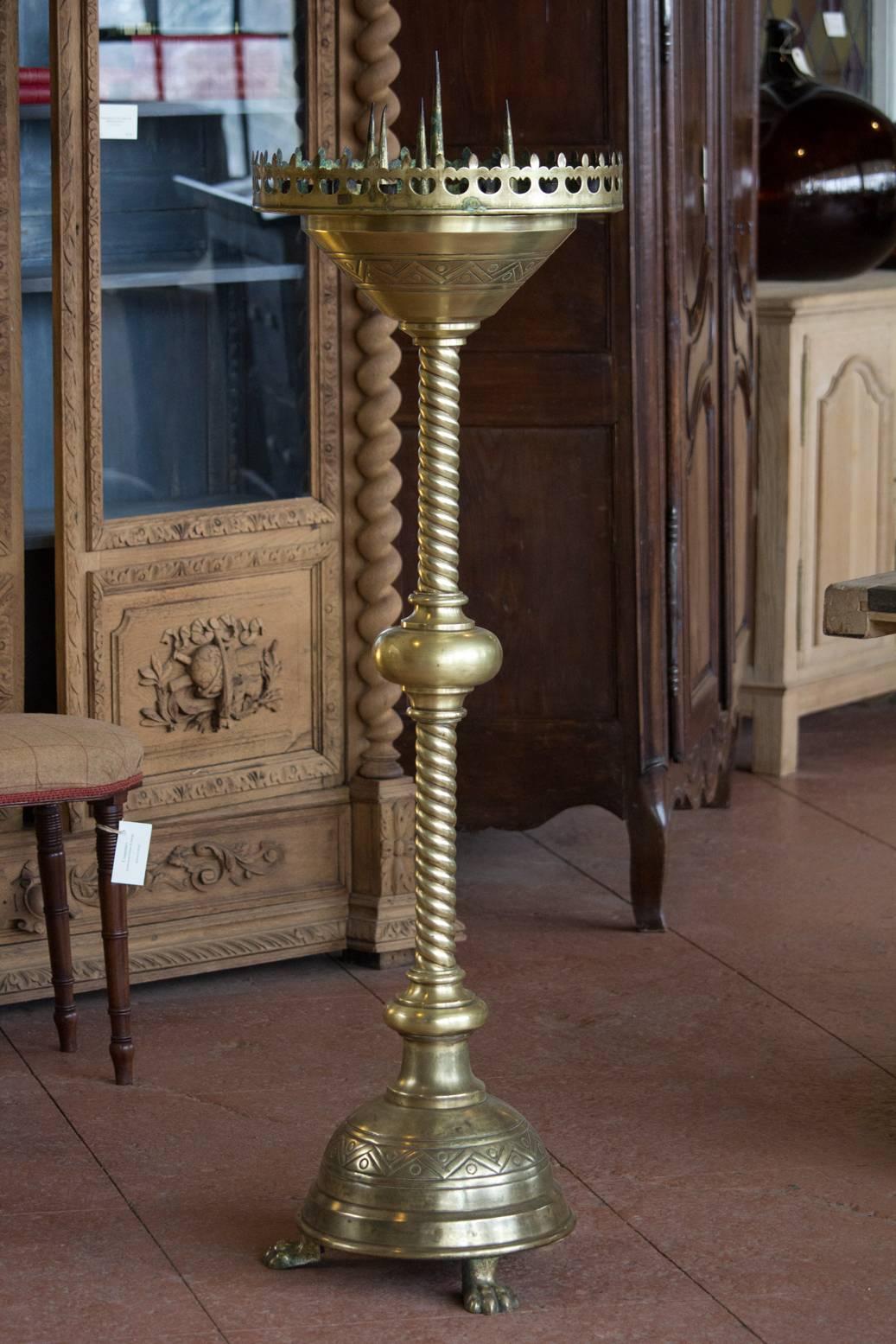 Antique Pugin style Gothic Revival brass torchiere with crenelated fleur de lis and wrythen column support.