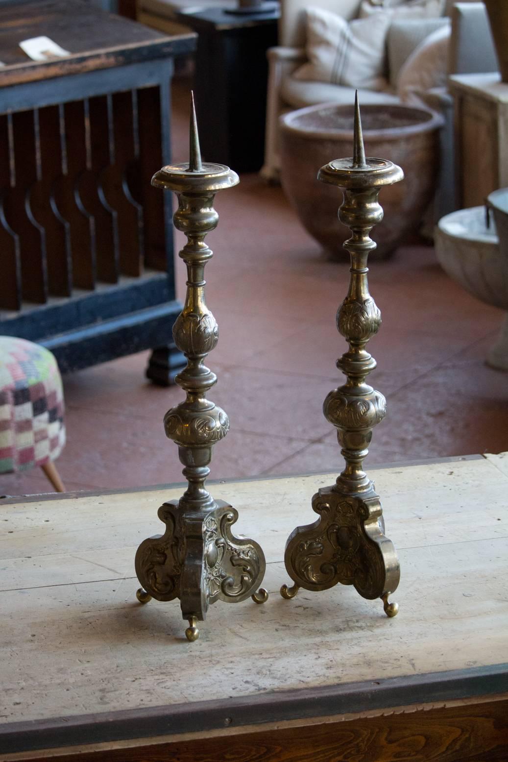 Pair of antique brass pricket candlesticks, with embossed foliate and beautiful patina. Baroque embellishments.