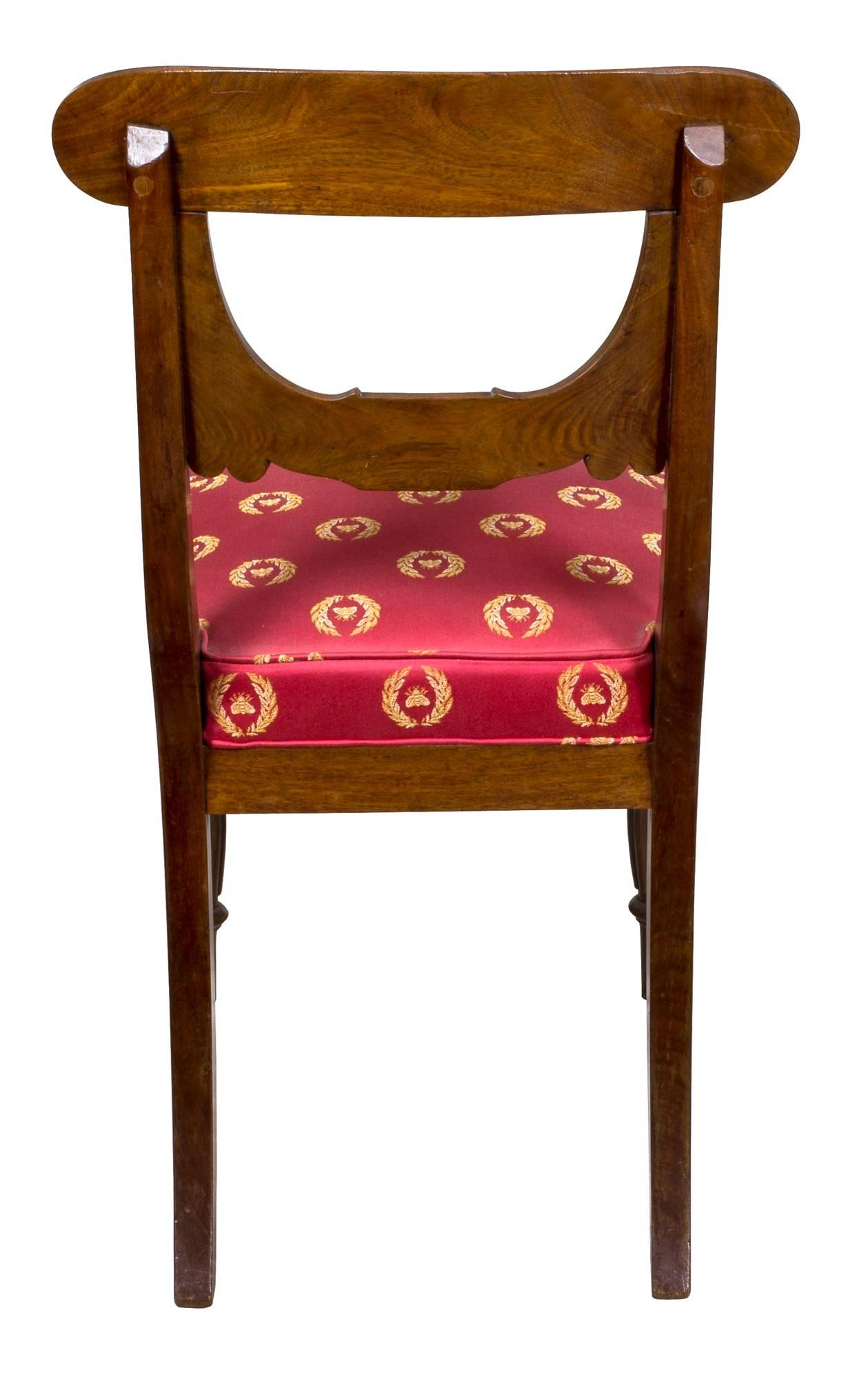 This set of chairs is the only one known with the bulbous reeded front leg and commodious original box seats, which make for a most comfortable and sturdy dining room chair. 

The main stylistic theme is the stylized drapery type backsplat which