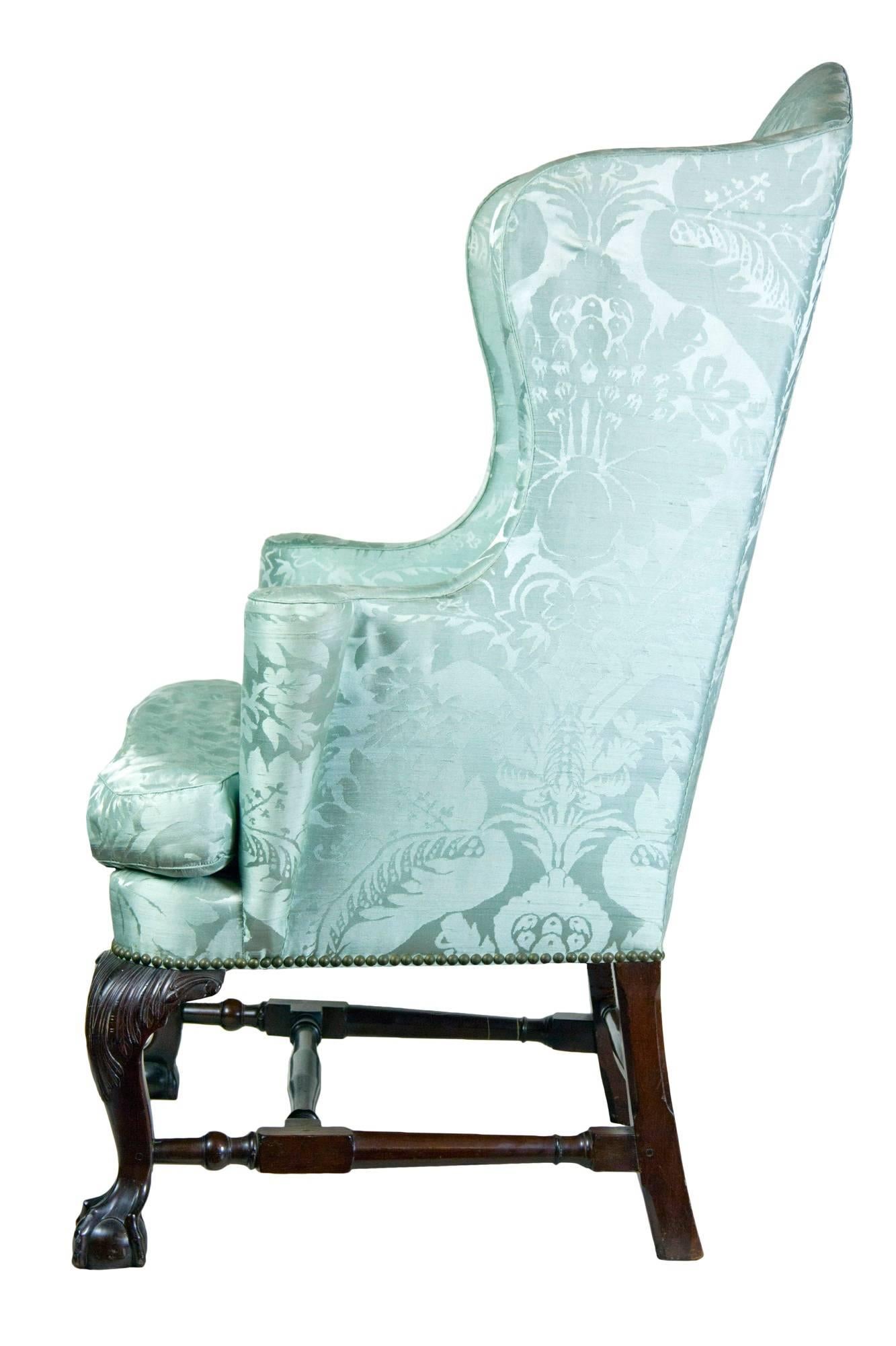This is the best, most highly developed form of the colonial wing chair produced in Boston, circa 1760. A mate to it is in the MFA (see scanned image below). This chair makes a bold statement with its highly desirable form, including shaped wings,
