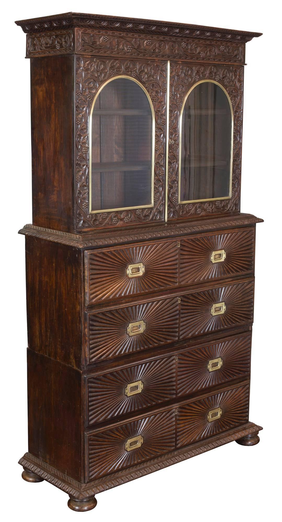 This secretary is crafted from rich, dense rosewood exhibiting the fluted sunburst motif and gadrooned edging. A chest of this grouping was offered recently by a local dealer. The carving in the upper case is of the finest quality. Note the very