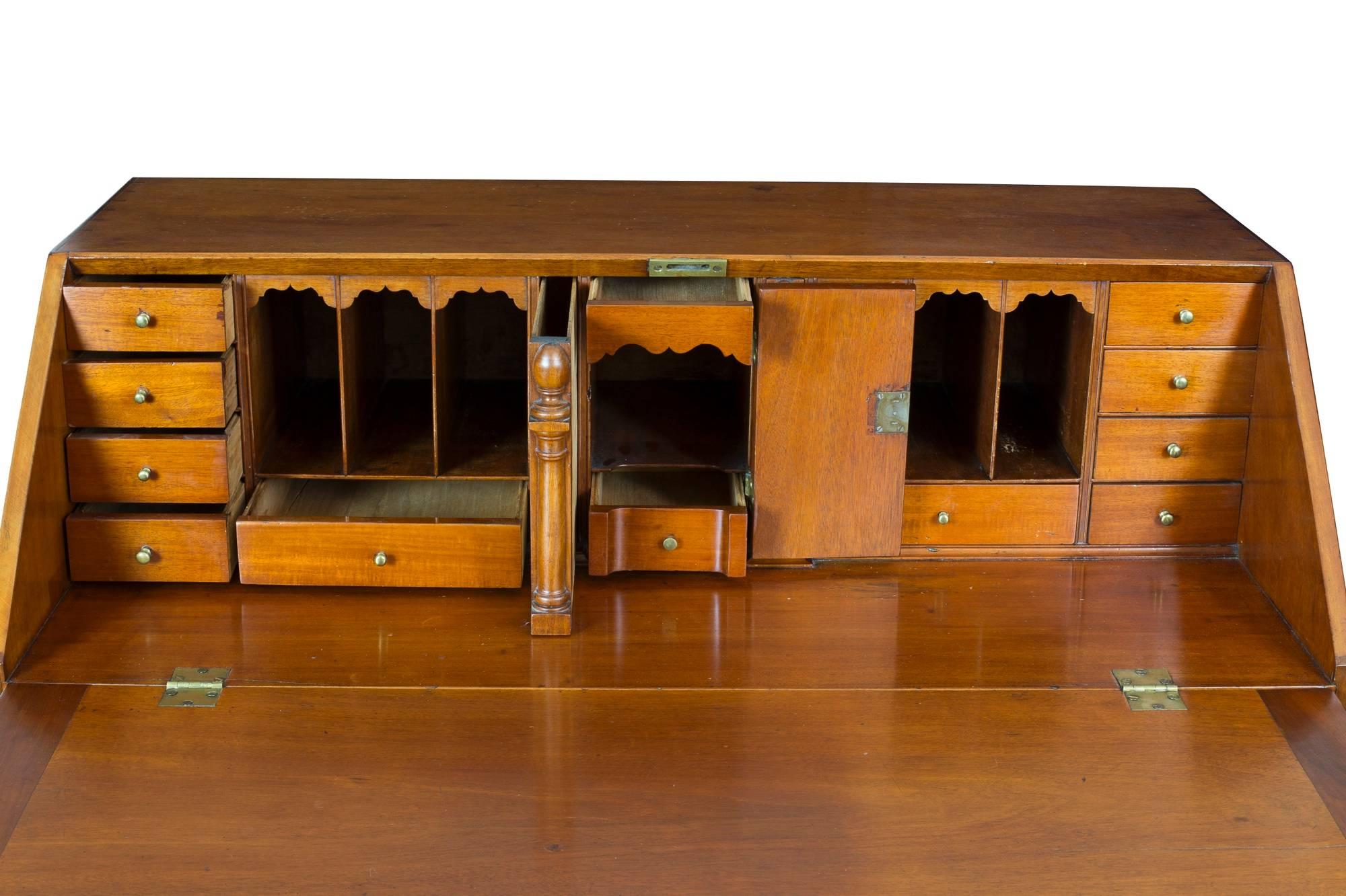 This is an estimable serpentine desk with blocked ends on magnificent gadrooned feet. Interestingly, the mahogany is blond and it gives warm amber tones of great depth. Unlike many of these serpentine desks, which have very plain interiors, this