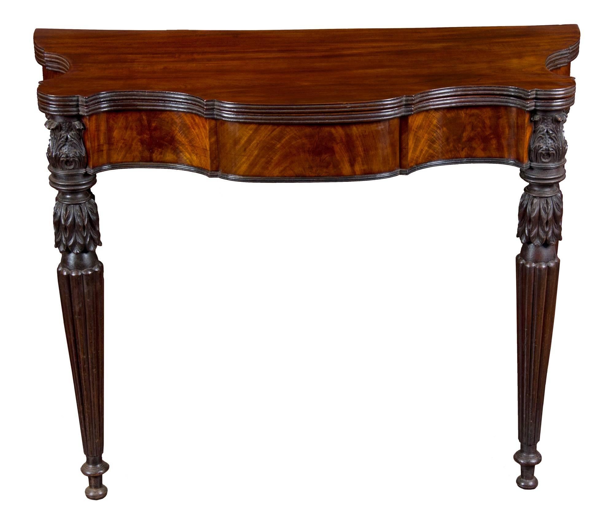 This is an outstanding Sheraton card table with an extenuated shaped top in immaculate, most desirable condition. This model is extremely successful because of the gracious serpentine swing to the front apron creating an image reminiscent of the