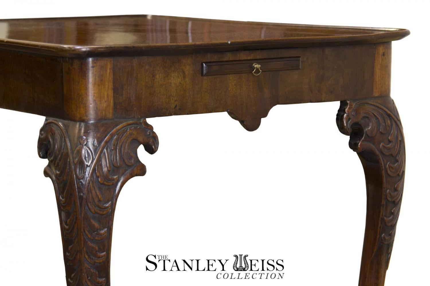 Of special interest are the carved eagle heads which evolve out of the acanthus carving on each leg. The tray top has a very nice patination, as does the rest of the mahogany (see details). 

The mahogany is very fine and dense. The square paw