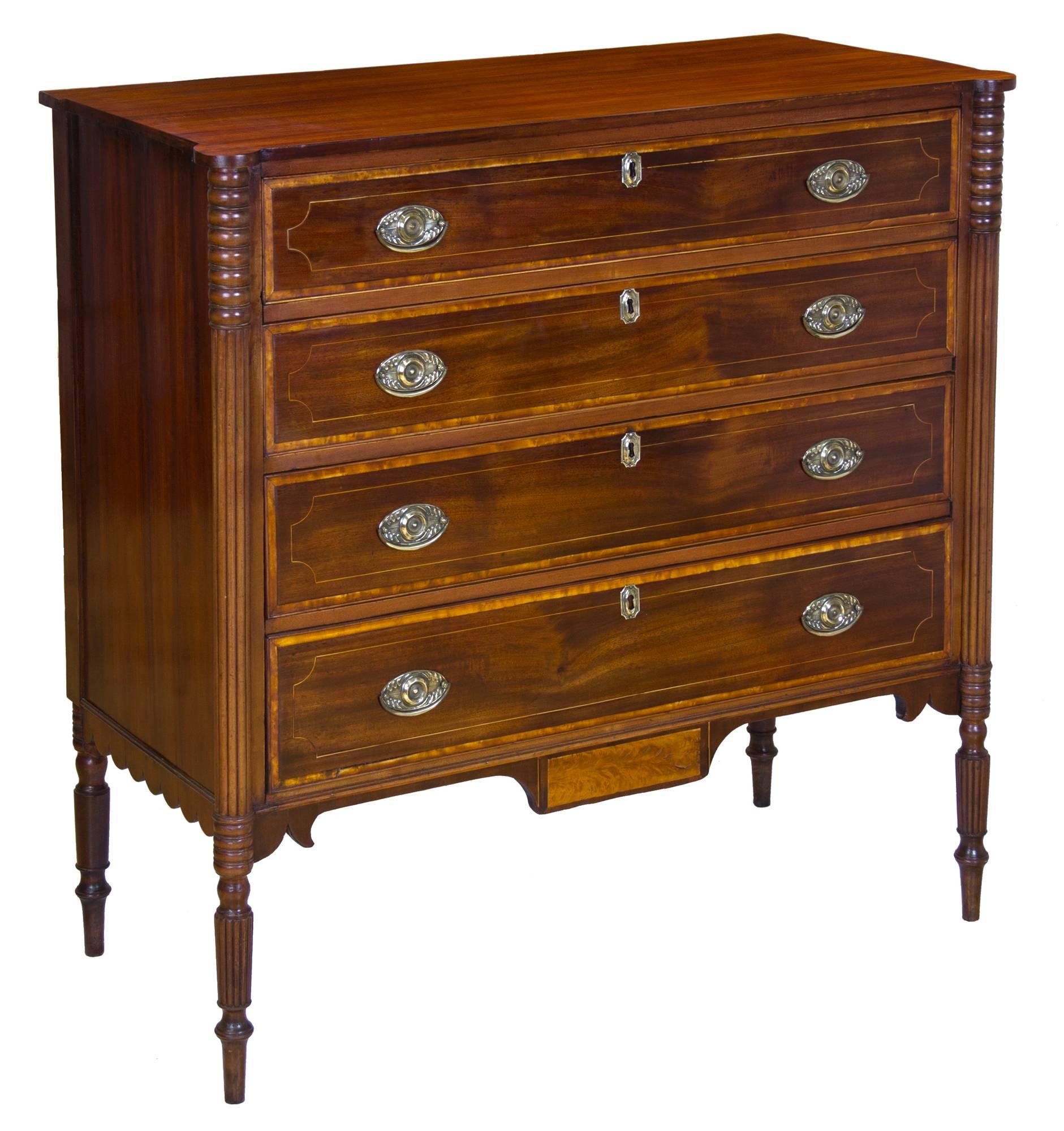 This chest is beautifully executed and embellished with the top most desirable elements in this grouping of furniture. Note the beautiful satinwood drop panel (and view close-ups.) The case is further embellished and supported by strongly reeded