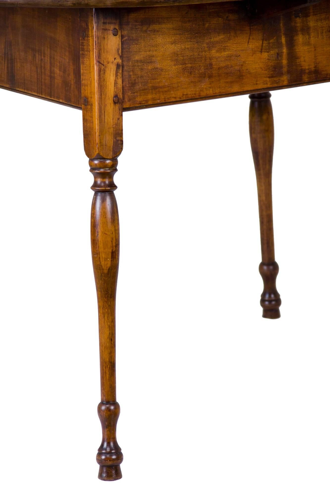 This tavern table is ideal for two people, given its generous size for the form. The top is maple--a hardwood--which is unusual, as these are often pine. The top has an old scrubbed surface that has been cleaned and washed through the years. Note,