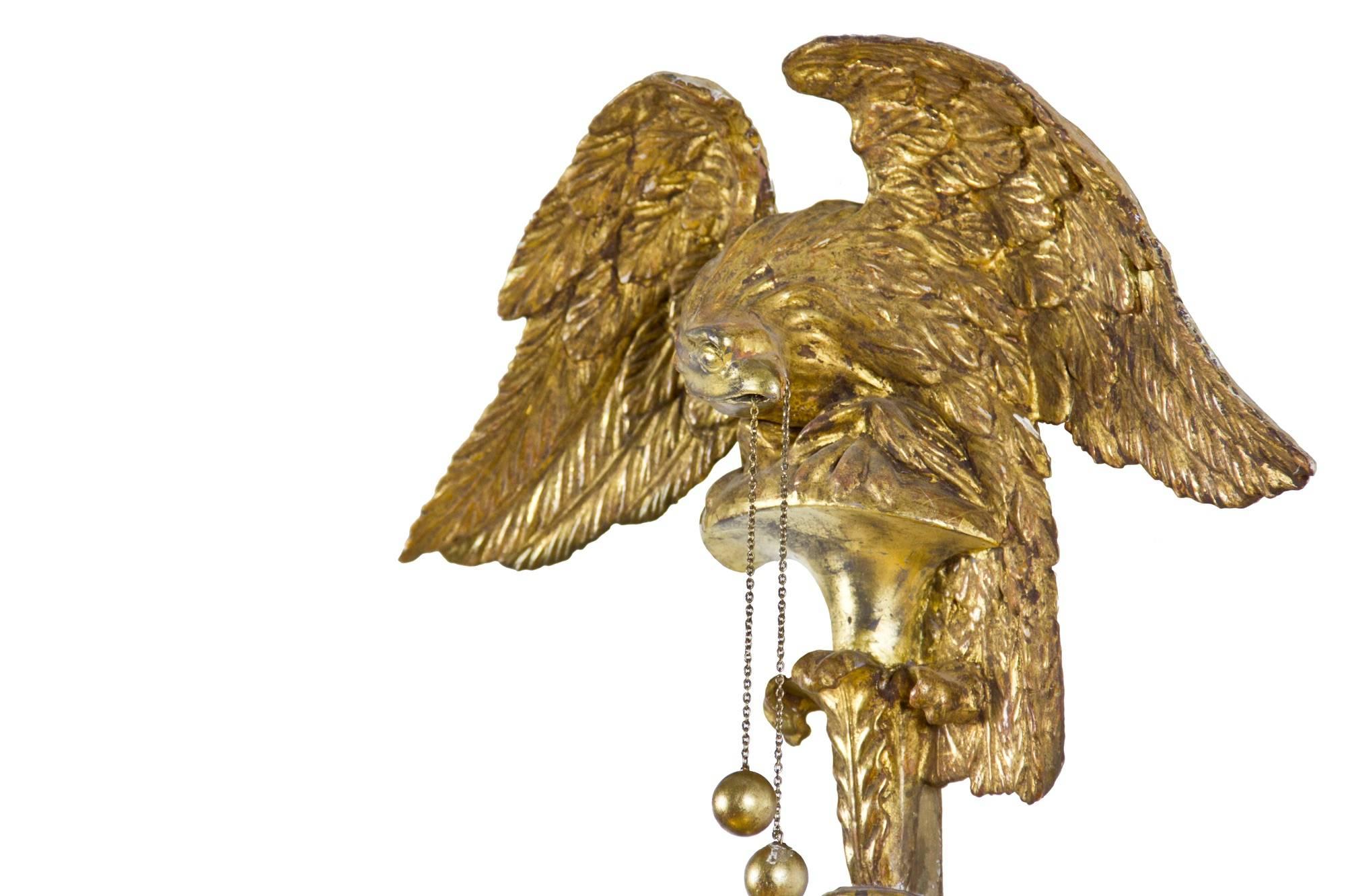 This is a very elegant girandole that has a very vertical aspect to it. Note the eagle, which is beautifully carved, sitting on a very high plinth above a robust and well carved spray of leafage, conforming to bracket carved leafage below the