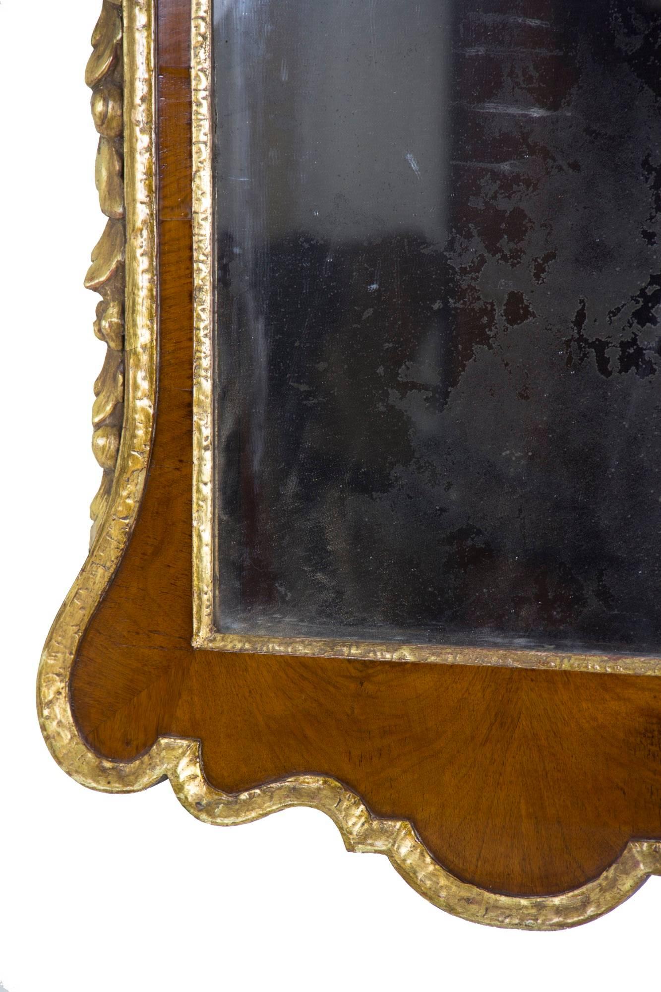 This is a good-sized top of the line Chippendale mirror with a substantial and beautifully carved Prince of Wales feathers finial which, although pursued by some, is not as commonly found as the eagle. It has a good sized scroll pediment with