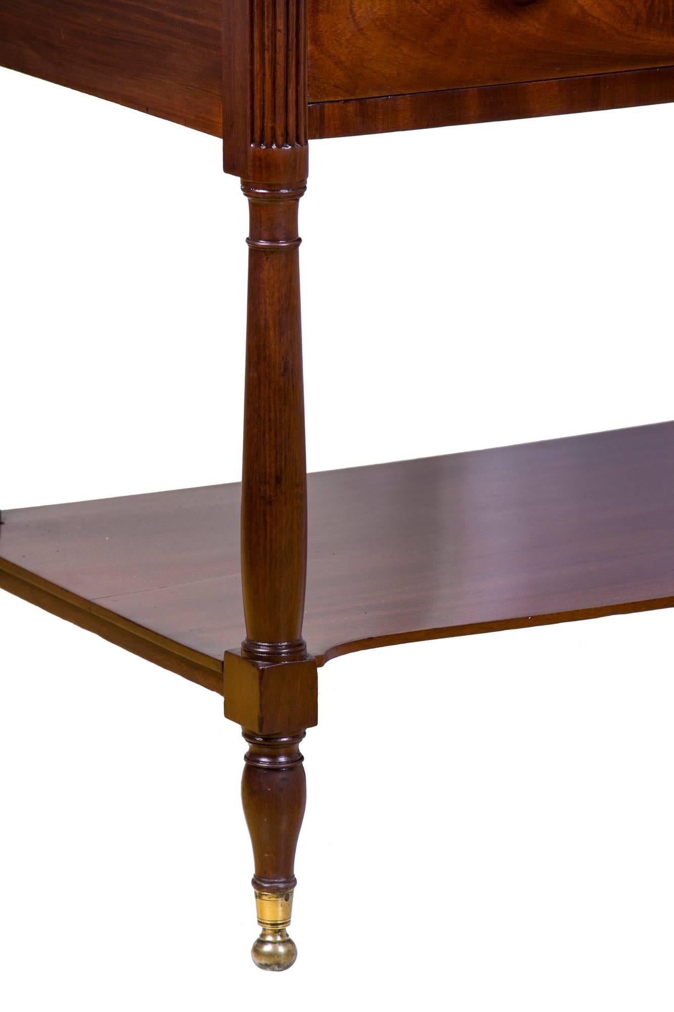This is a quintessential New York Classical server of the Phyfe school. The top is composed of solid striped mahogany and the mahogany throughout is vibrant with its historic surface under a finely French polished finished. There are no repairs,
