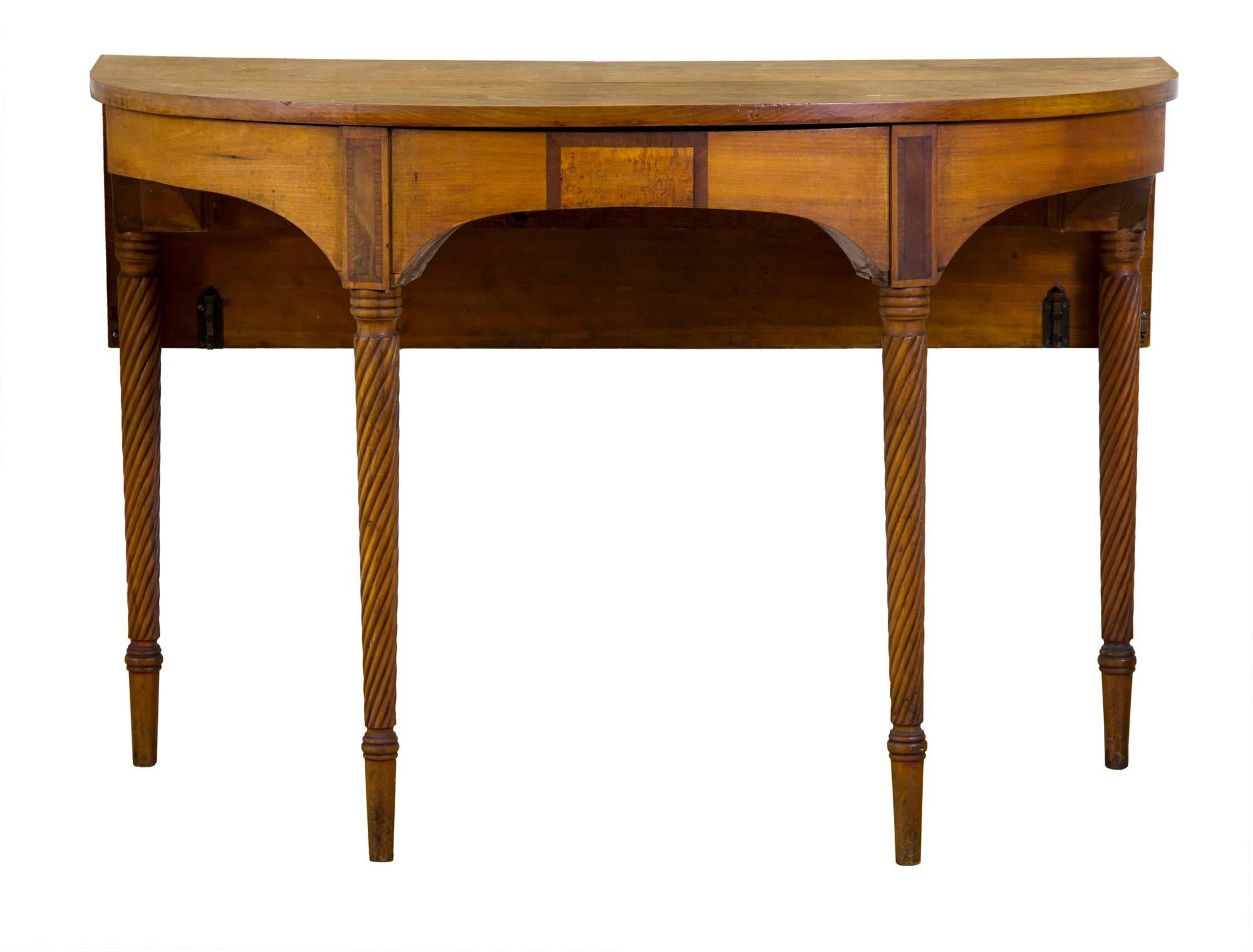 This is a “country-fied” version of the formal Federal style dining table which was popularized at the turn of the 19th century, and remained in style for 20-30 years.  This table has striking looks; its top is solid cherry wood that has turned a