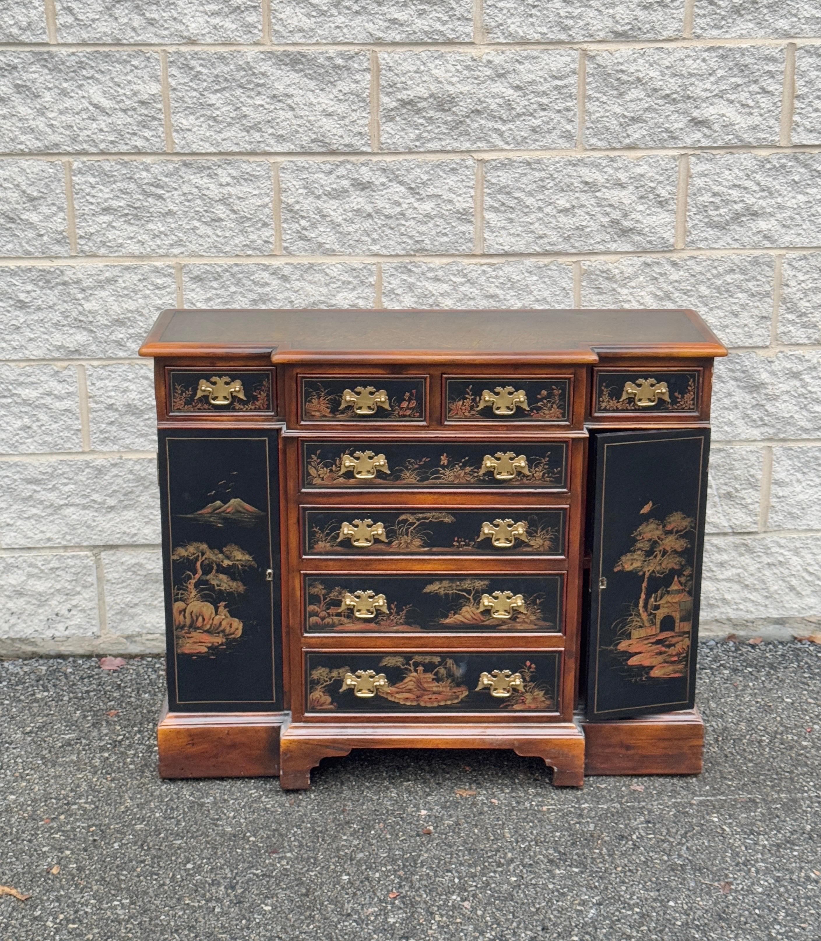 Chinoiserie server cabinet featuring a finely detailed tooled leather top. This decorator piece offers a compact design with dimensions of 32 inches in height, 40 inches in width, and 14 inches in depth, making it ideal for small spaces. Perfect for
