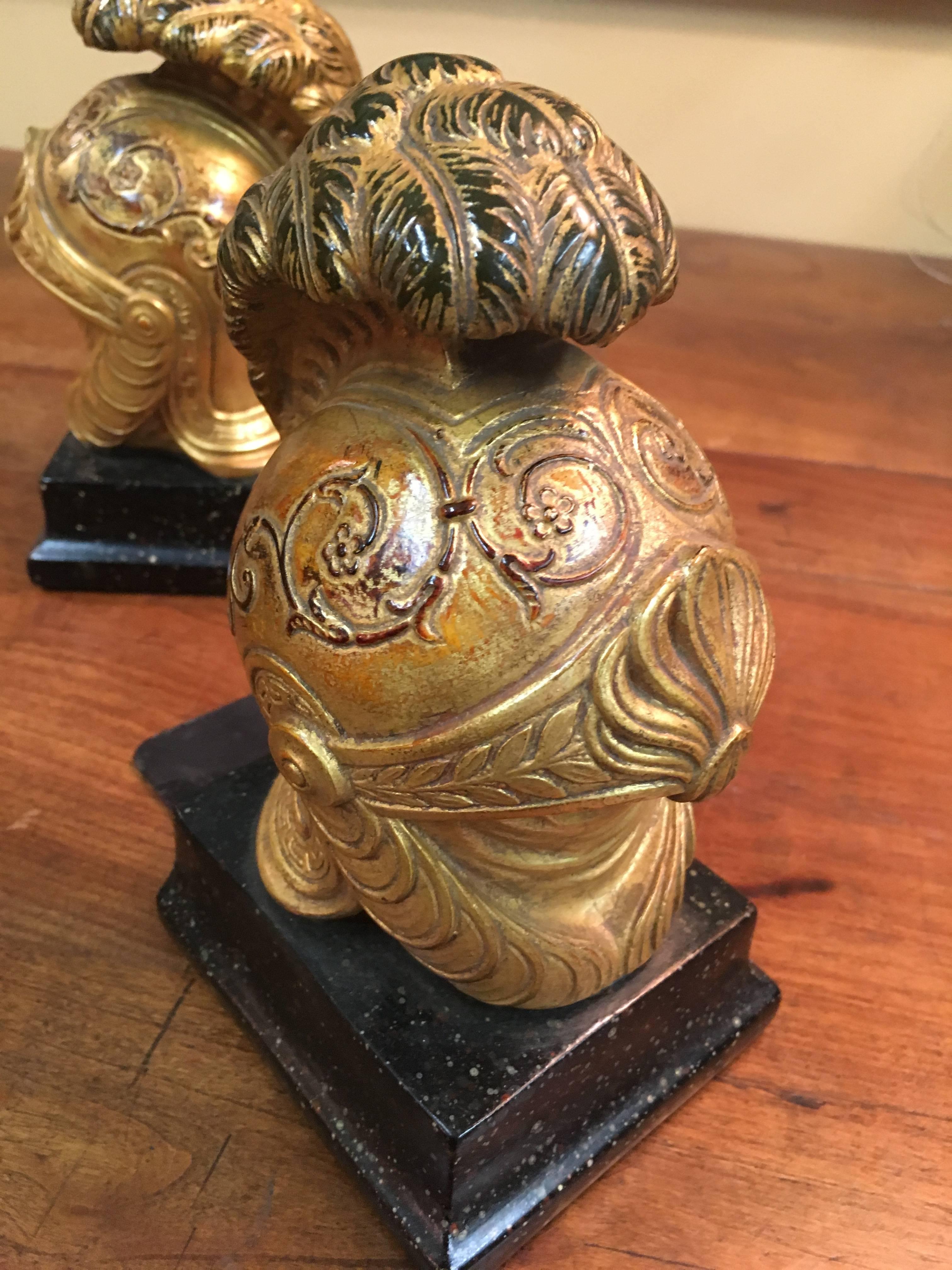 Stunning pair of Roman Galea Book ends - gilt and impressive. For the Roman Enthusiast or if you just really into helmets! These are great for the kids room or masculine office - or perhaps your a Damsel, but secretly wished you were a Knight!