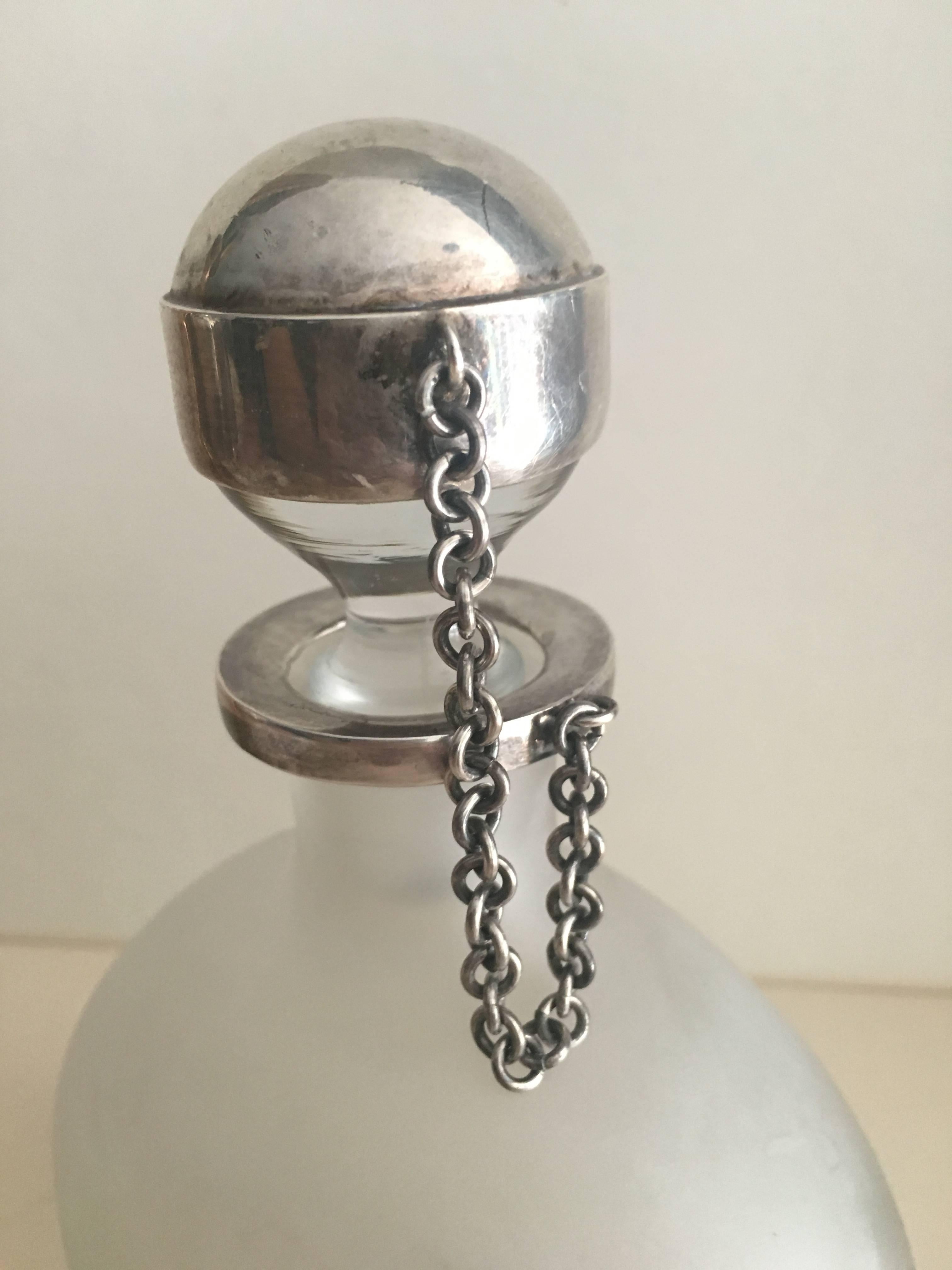 Beautiful frosted bottle with sterling silver stopper on chain.

Why limit yourself, easily used for olive oil, balsamic, perfume or a fine Kentucky whiskey! Contents matter not when the container is the center of attention.