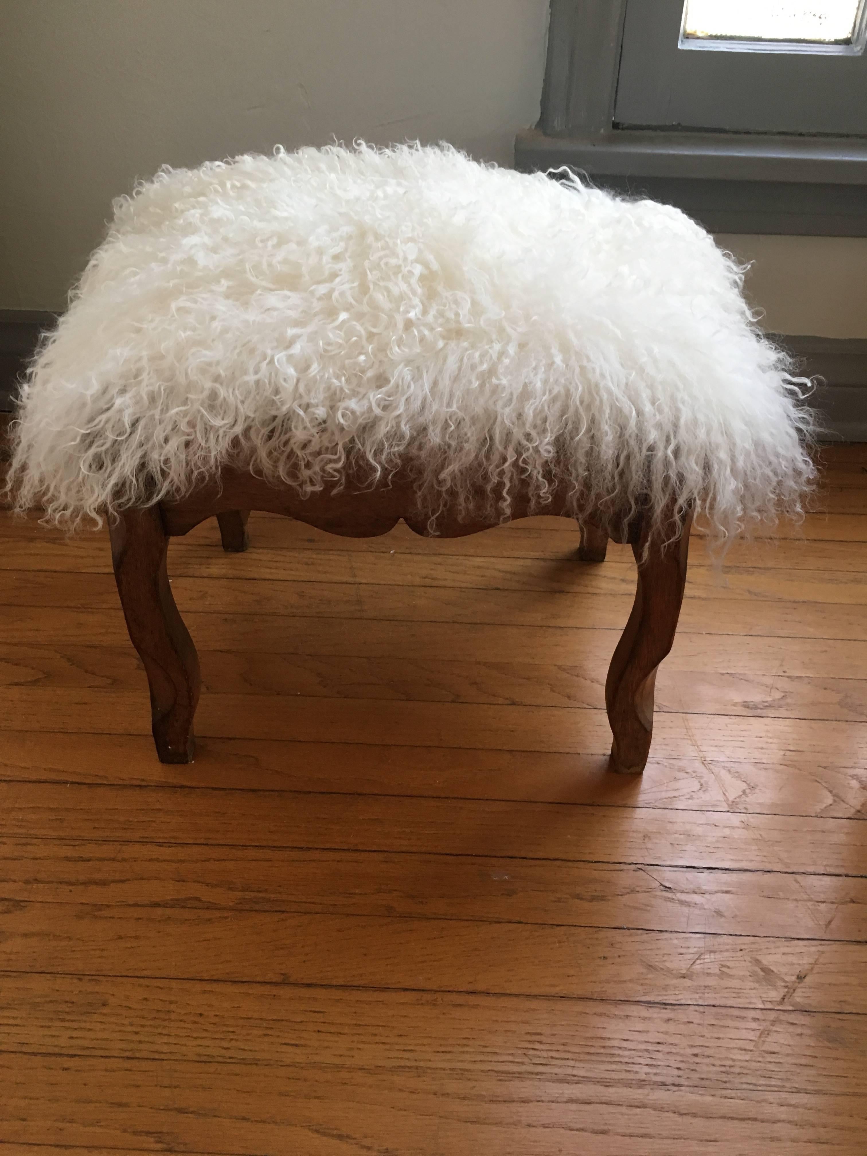 Carved step stool covered in Mongolian Yak fur. Perfect for a small statement piece and to, of course, rest your feet!