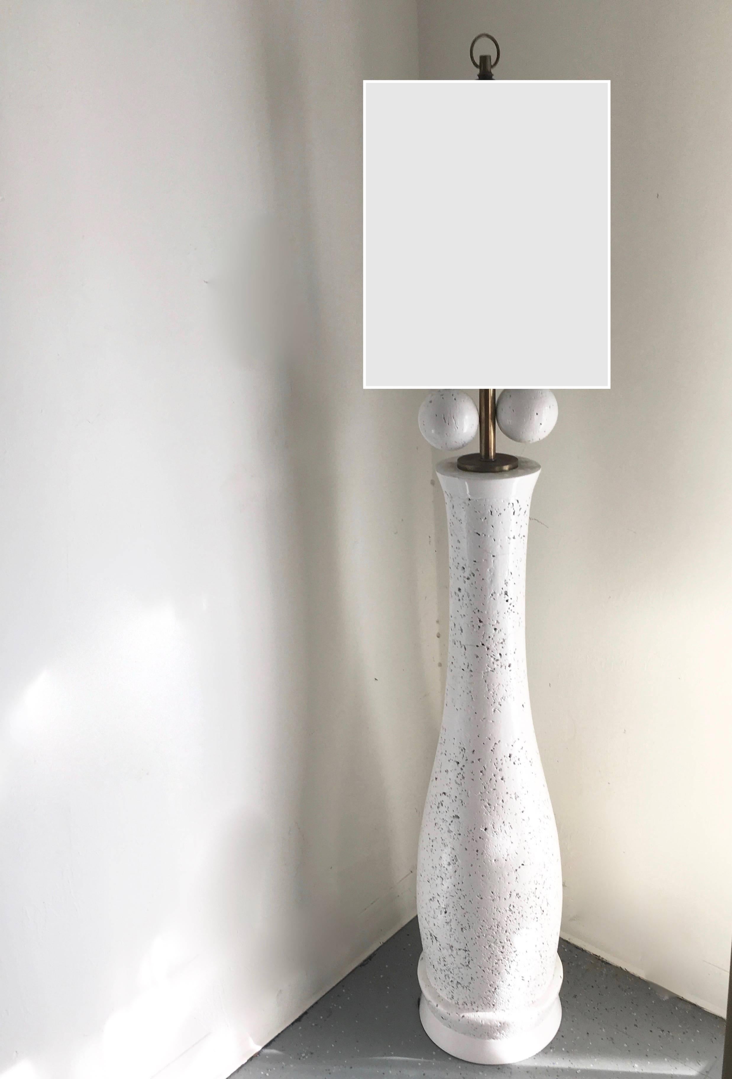 Milo Baughman floor lamp of lacquered cork, a very special lamp with terrific proportions and huge spheres for on/off pulls. While the lamp does not include a shade, we mocked one up in black and white.

For an additional fee we can make a custom