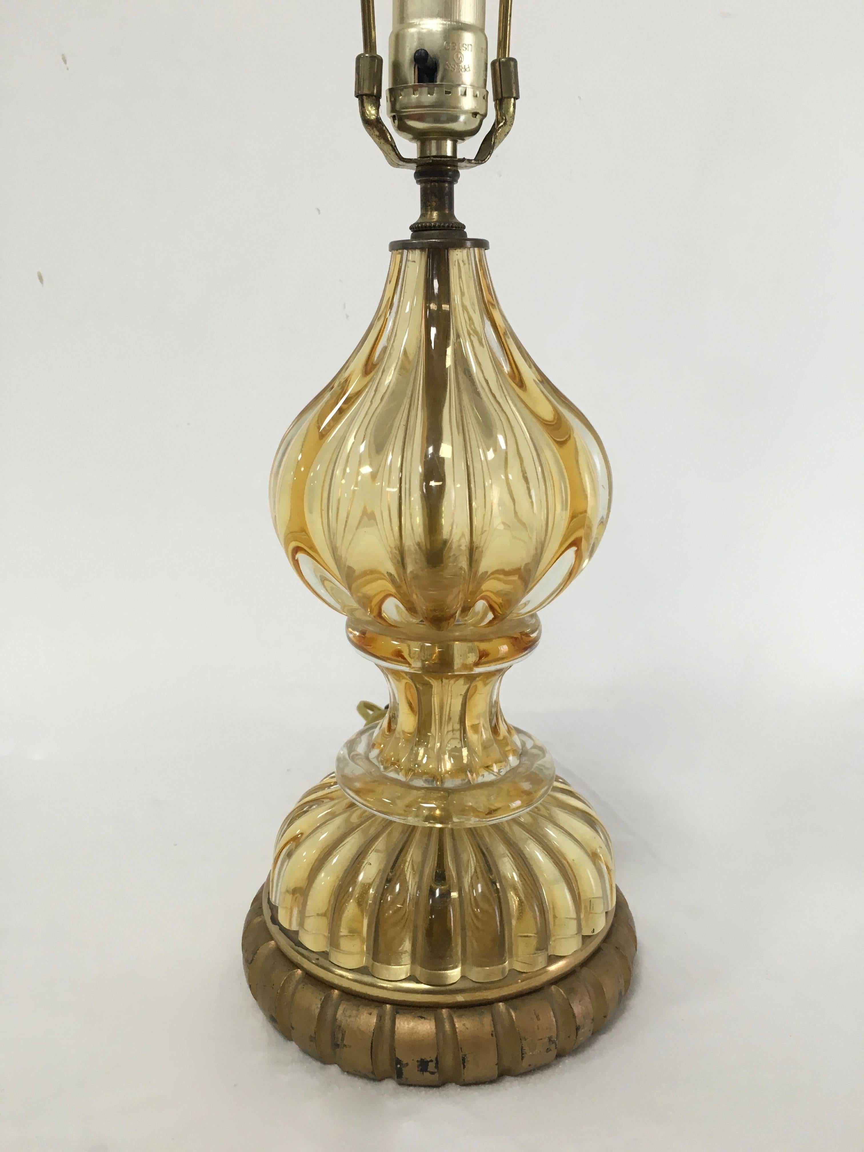 Simple, sophisticated and elegant gold Murano table, desk or vanity lamp with gilt carved base.

In the right house the Murano lamp could make a great statement anywhere, even the kitchen - low lighting is the sexiest and most appealing... and