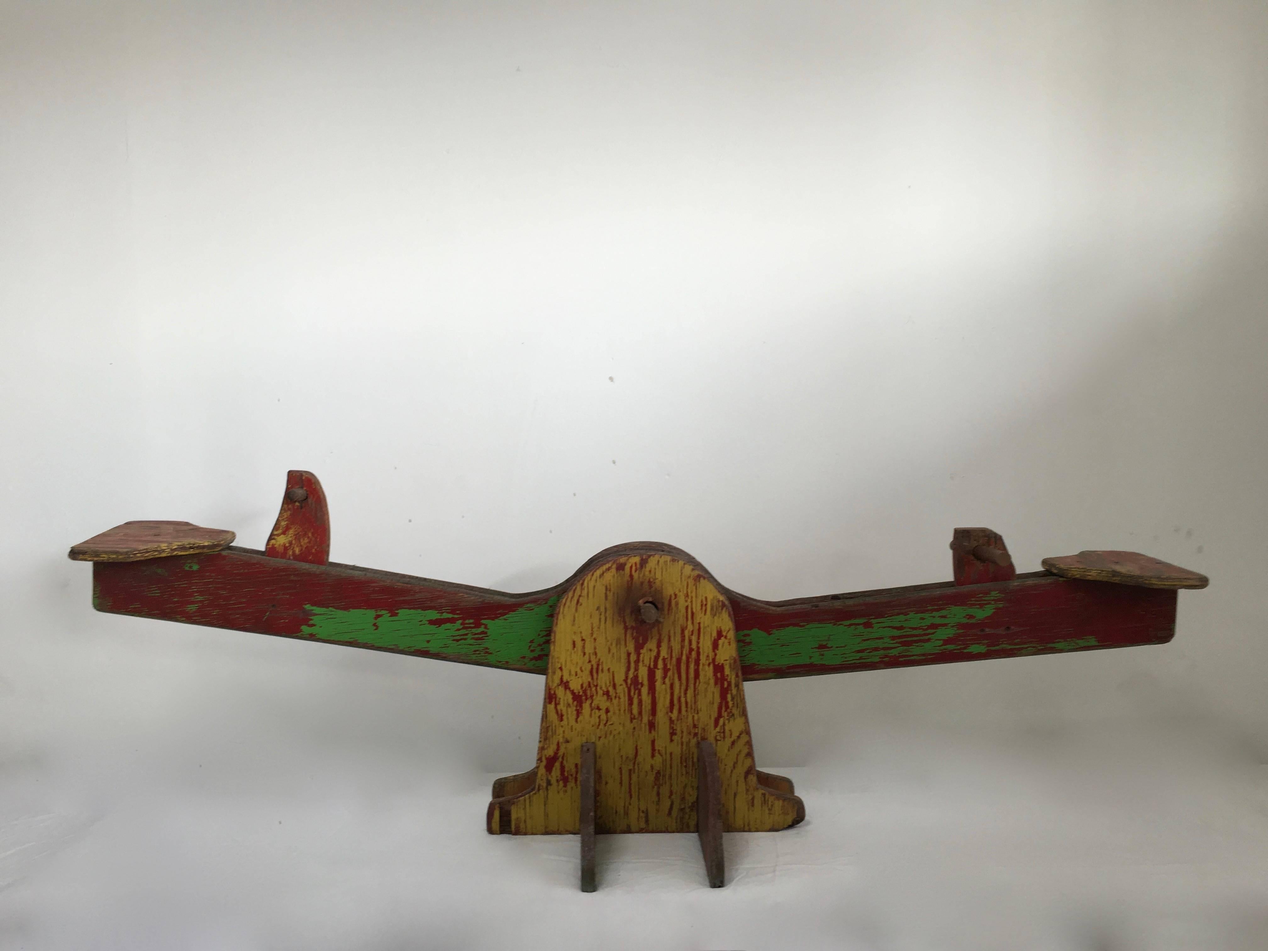 In the 1940s this child's see-saw was the go-to toy, handmade, and gathering over the years a perfect patina! Made of wood, this Folk Art piece, no longer a great practical toy, but a stunning work of art and piece of decor. 

Resting high on a