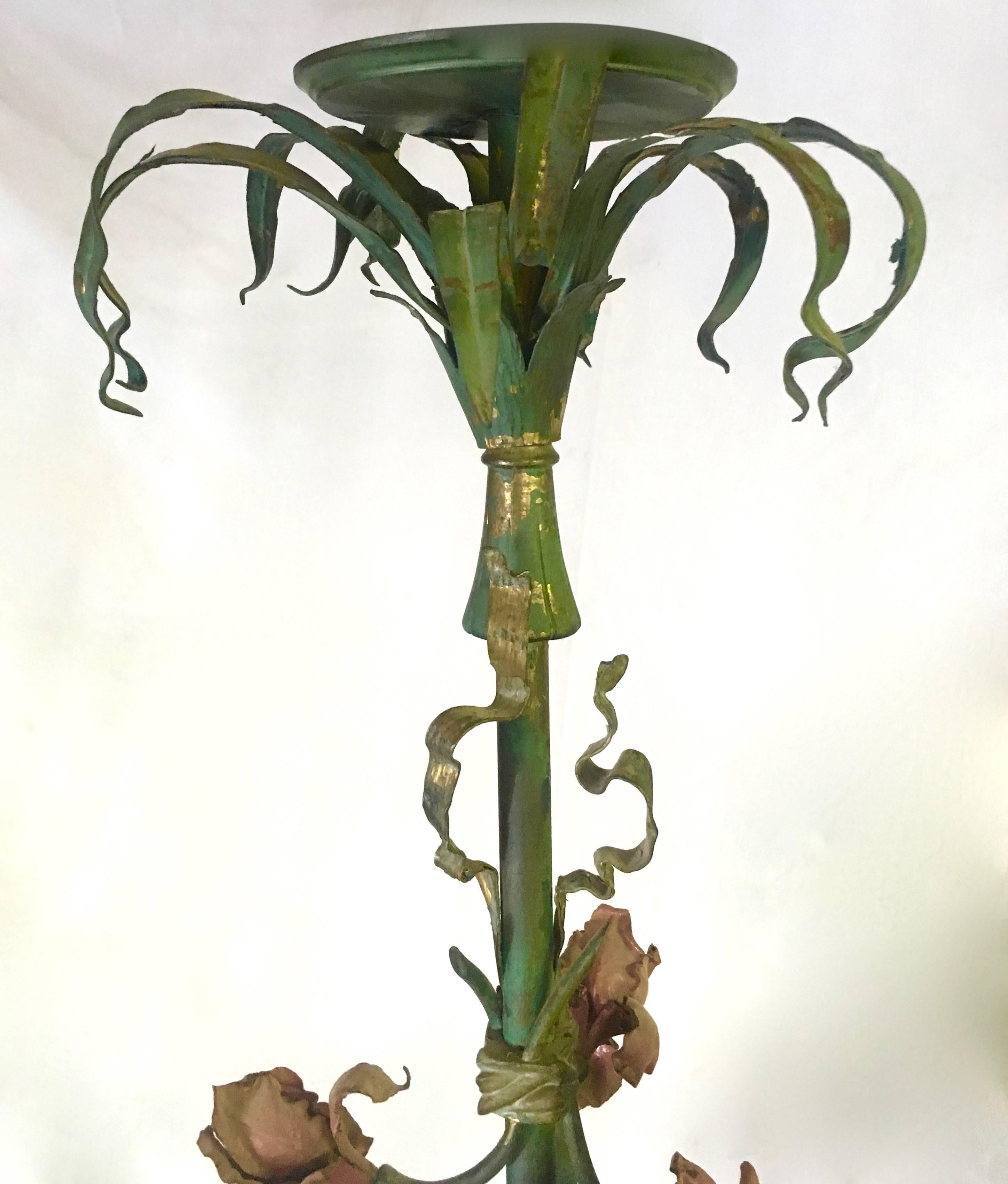 Exceptional tole chandelier purchased in Paris, early 1900s. The unique iris with foliage motif surrounded by a Louis XVI style bow creates a stunning look in any room. We encourage even the most contemporary looks to consider this as an