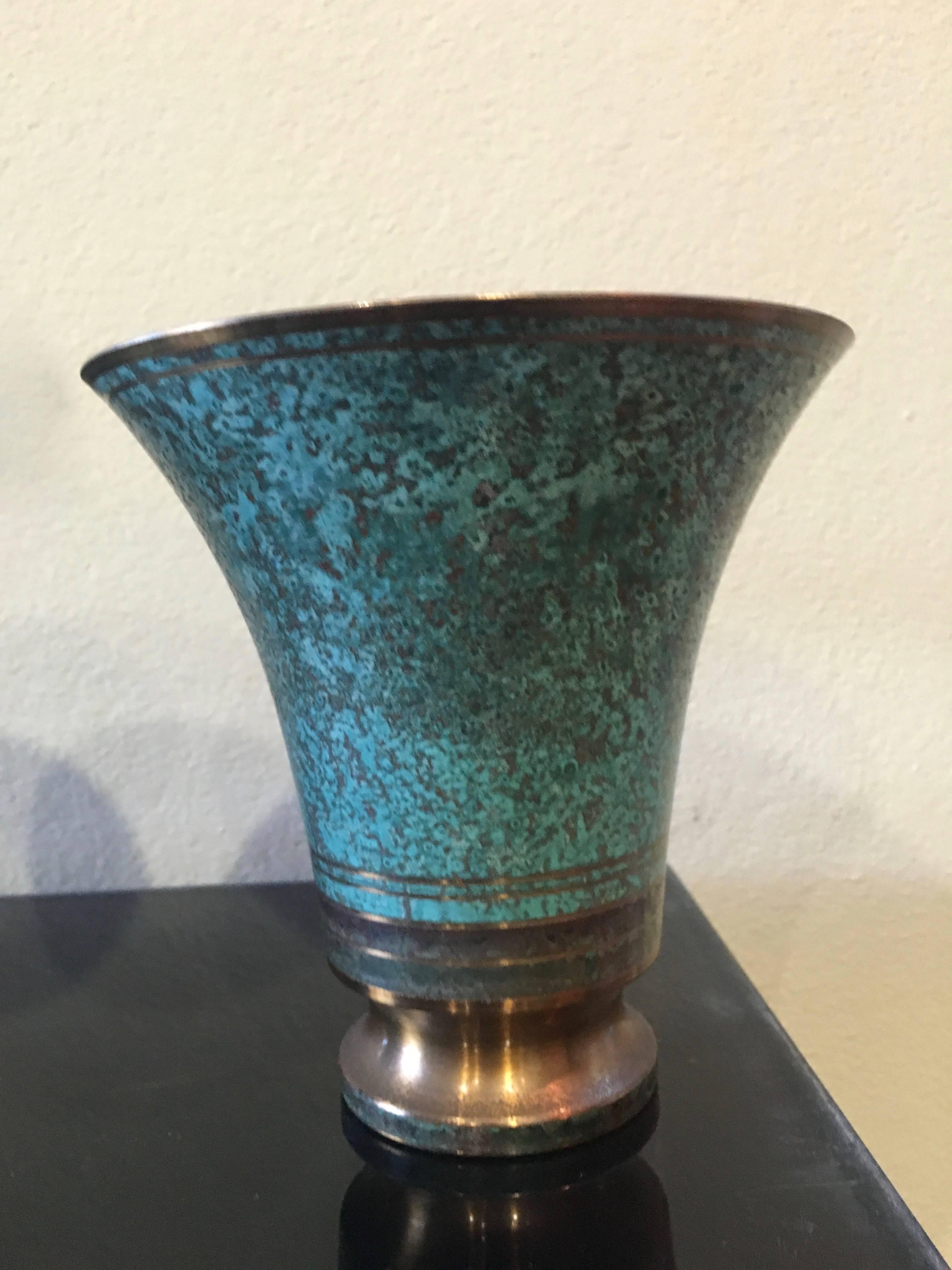 Beautiful Art Deco bronze verdigris vases designed and signed by Swedish Designer Carl Sorensen. 

This impeccable pair can stand in any room, flanking a table or used as a center piece. Filled or alone most definitely a statement piece.

Darren