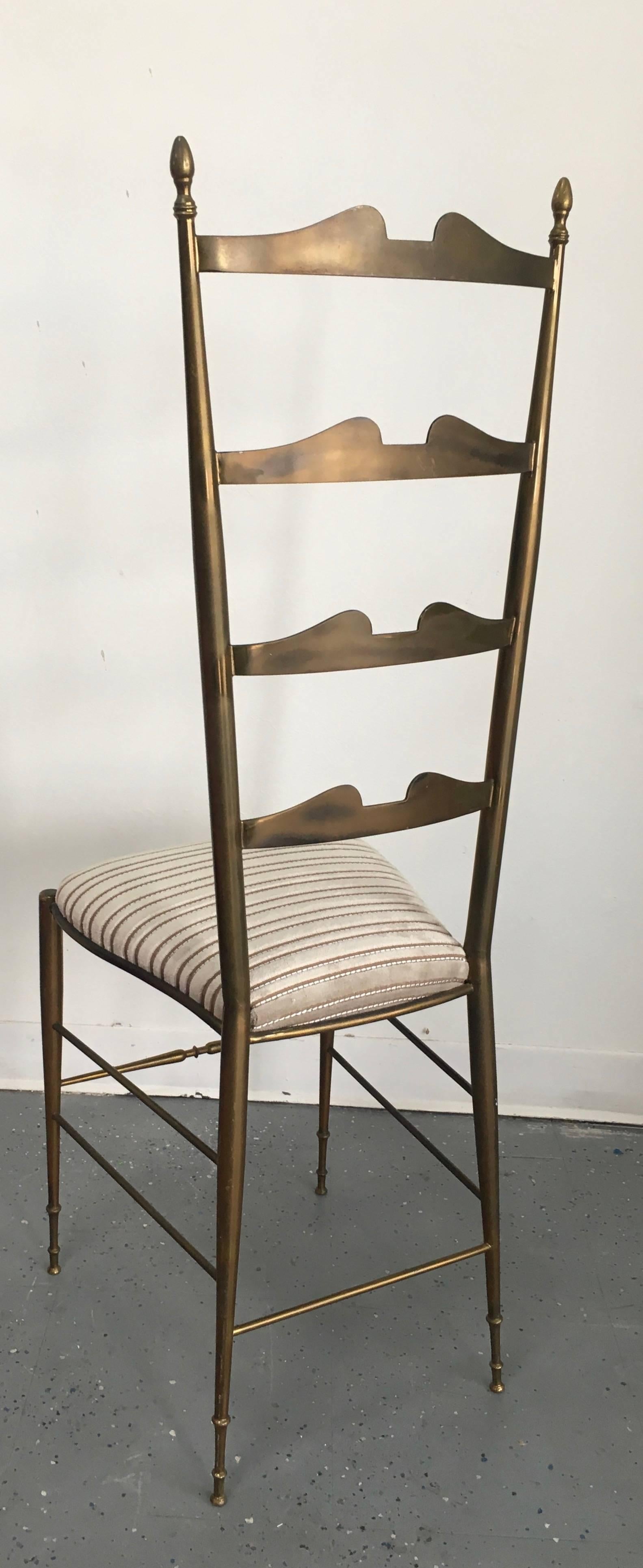 The ladder back Italian brass Chiavari chair attributed to Gio Ponti, is simple and elegant - alone making a functional statement. The chair is covered in Imported French Mohair and silk striped Upholstery. 

The chair alone would be a perfect