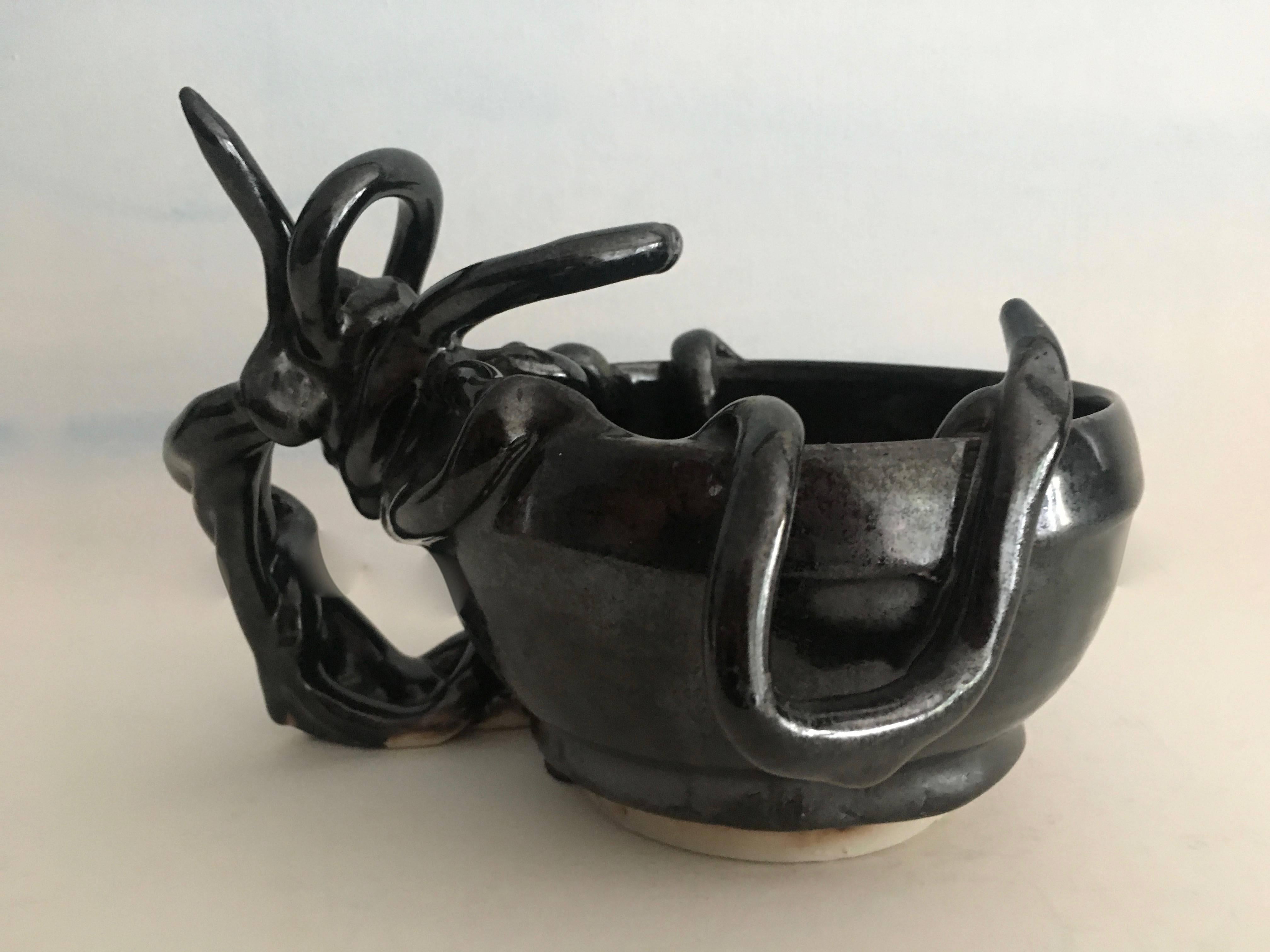 This unique and exquisite example of Japanese pottery is a one of a kind handmade piece unique in it's design - the piece can easily be a bowl, cup or vessel primarily for decorative display but could be utilized for candy nuts etc.