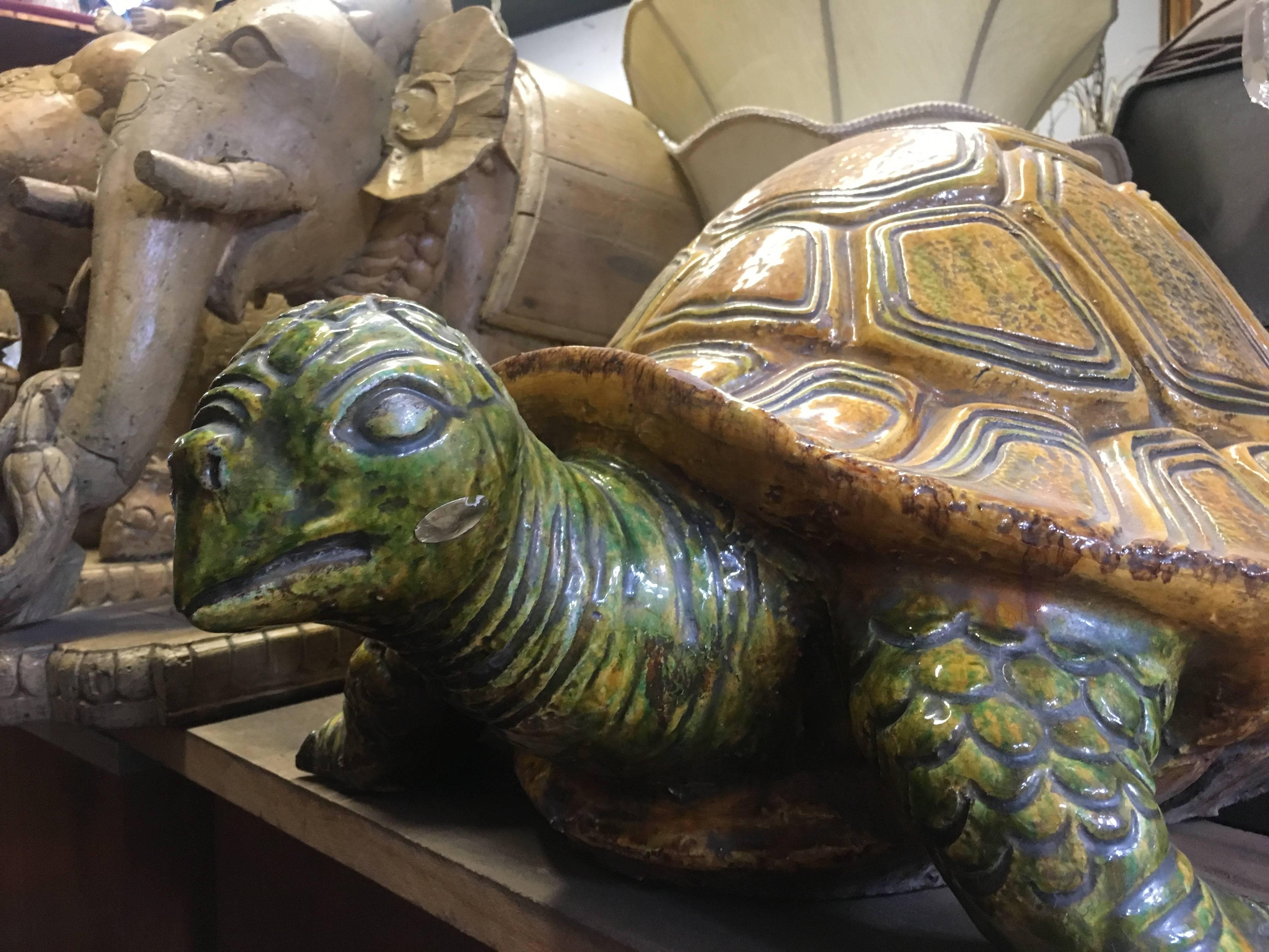 Monumental majolica turtle. The ceramic piece is very large and with great weight. Color perfection gives this turtle his perfect place inside or out, poking his head out of foliage or from under a console!

  