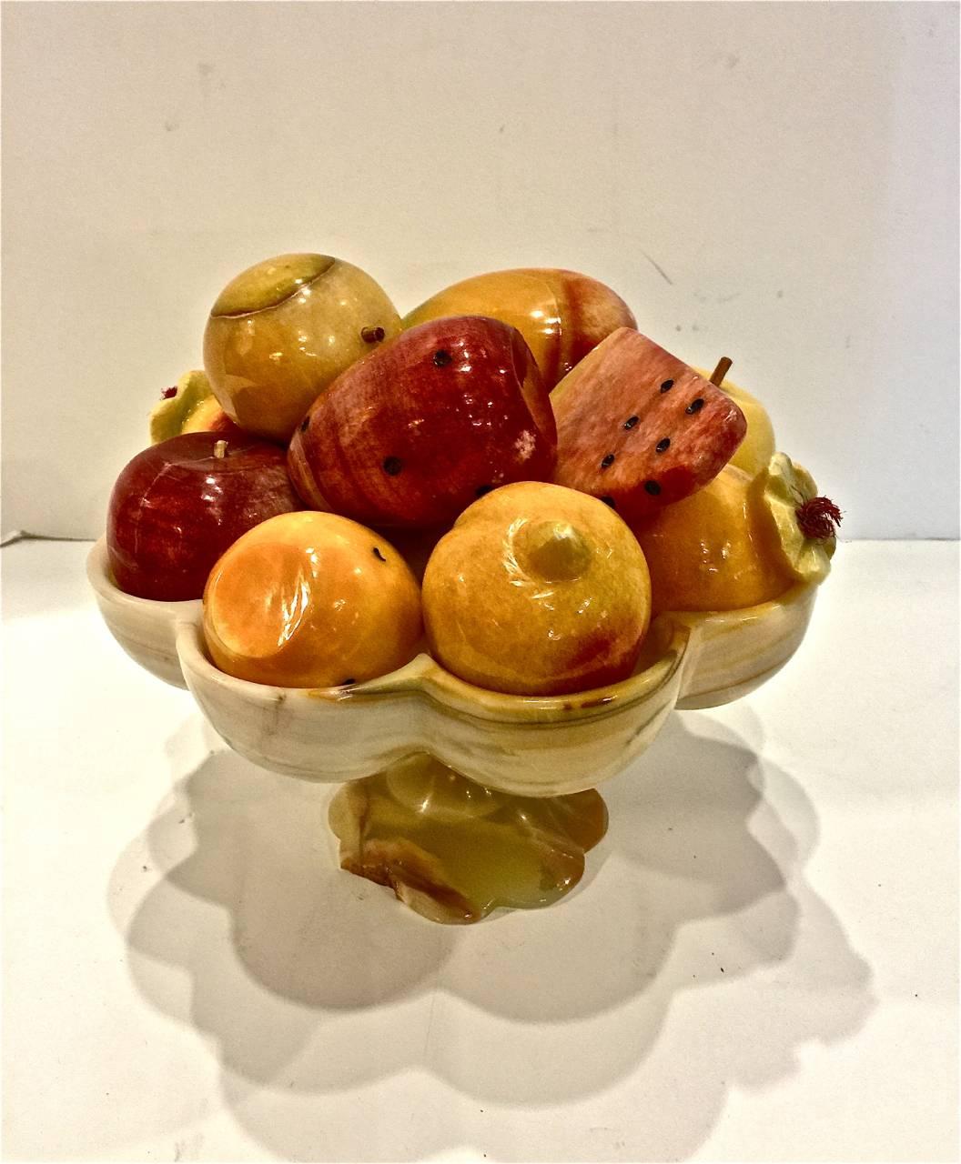 Charming mid-20th century Mexican carved onyx fruit bowl with 13 carved onyx fruit. There is a small chip out of the foot of the bowl, otherwise the bowl and fruit and in excellent condition. It is quite unusual to find onyx employed in this manner.