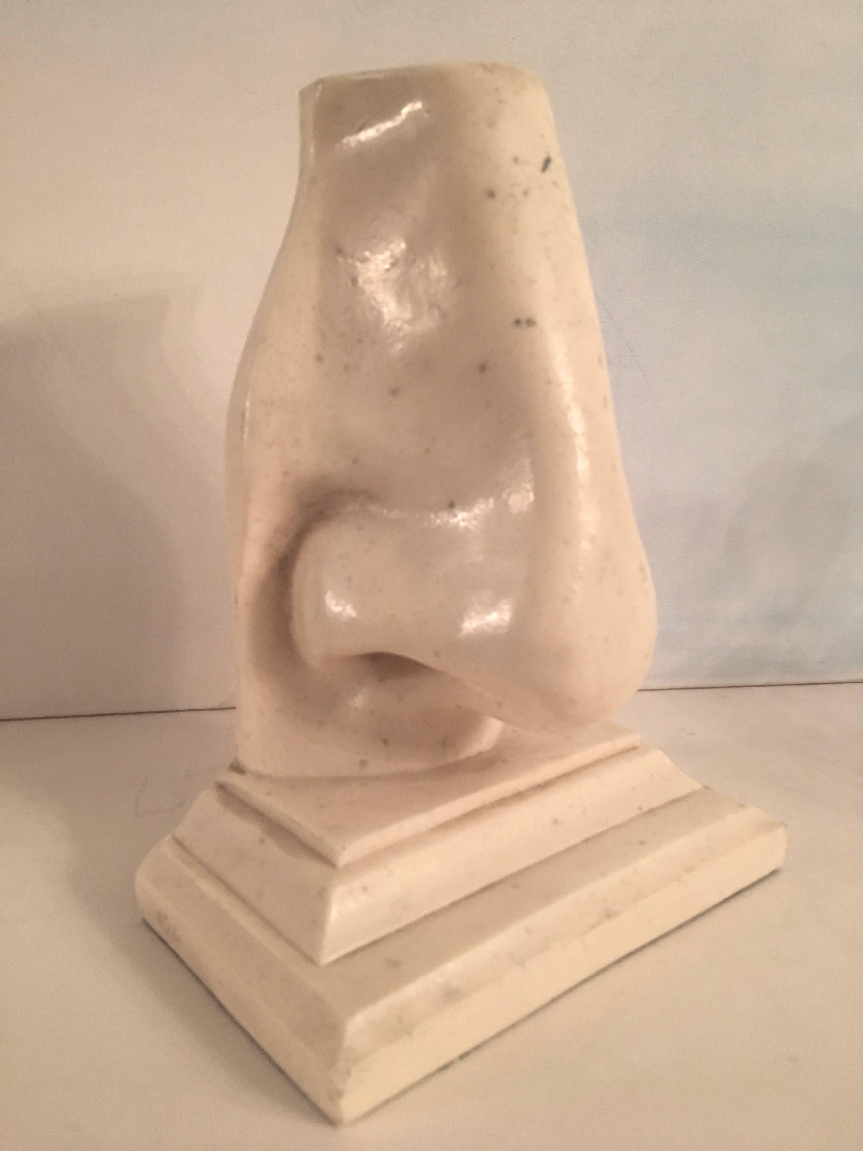 Oversized nose bookend made of composition marble and a perfect addition to the library for the nosy librarian!

A single piece, but we do have the pair available for an additional fee.