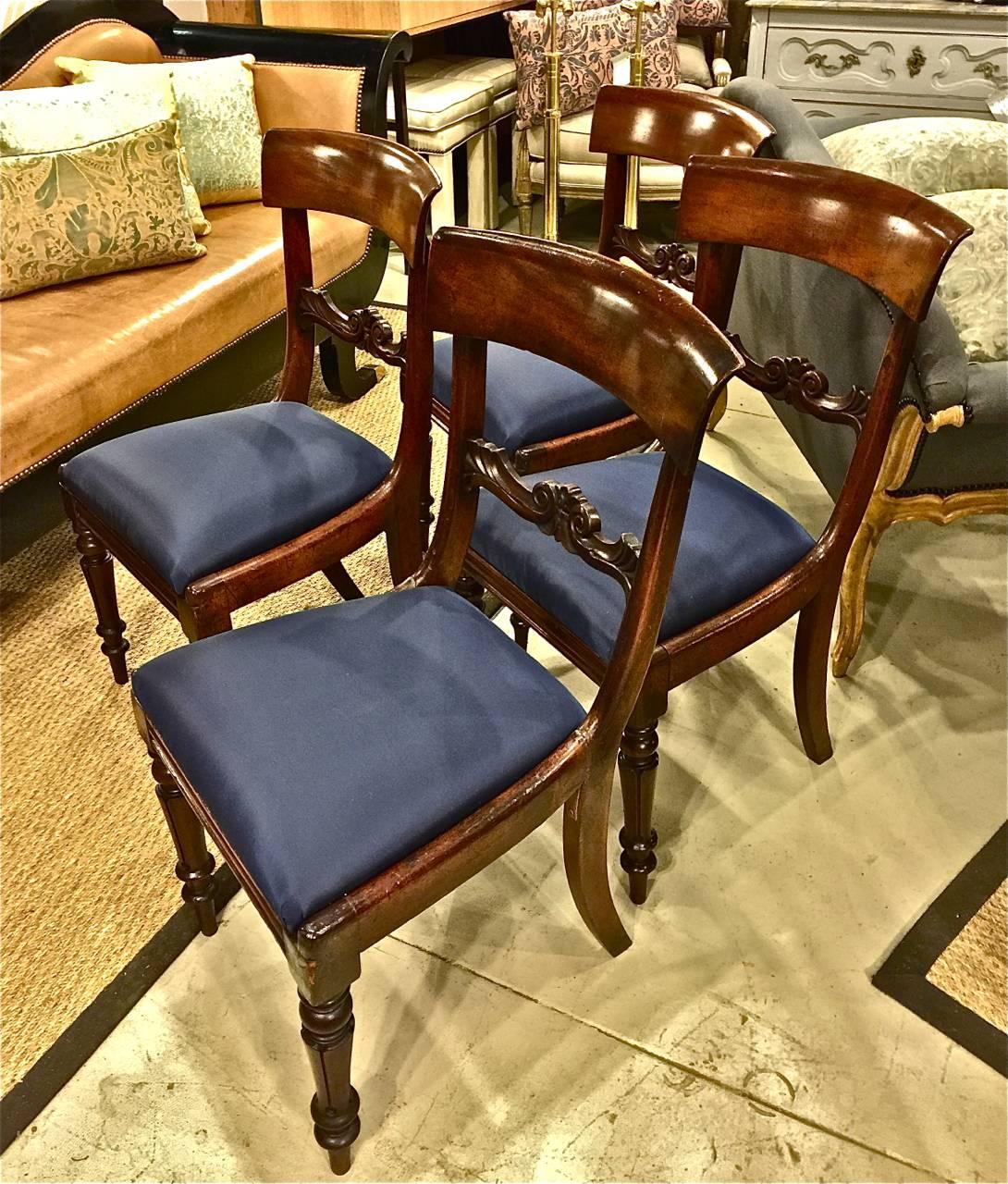 This is a great set of four period English Regency Klismos form side or dining chairs that date to circa 1820-1830. All chairs are in very good original condition with a couple of minor losses, as shown in photos. These klismos form chairs are of