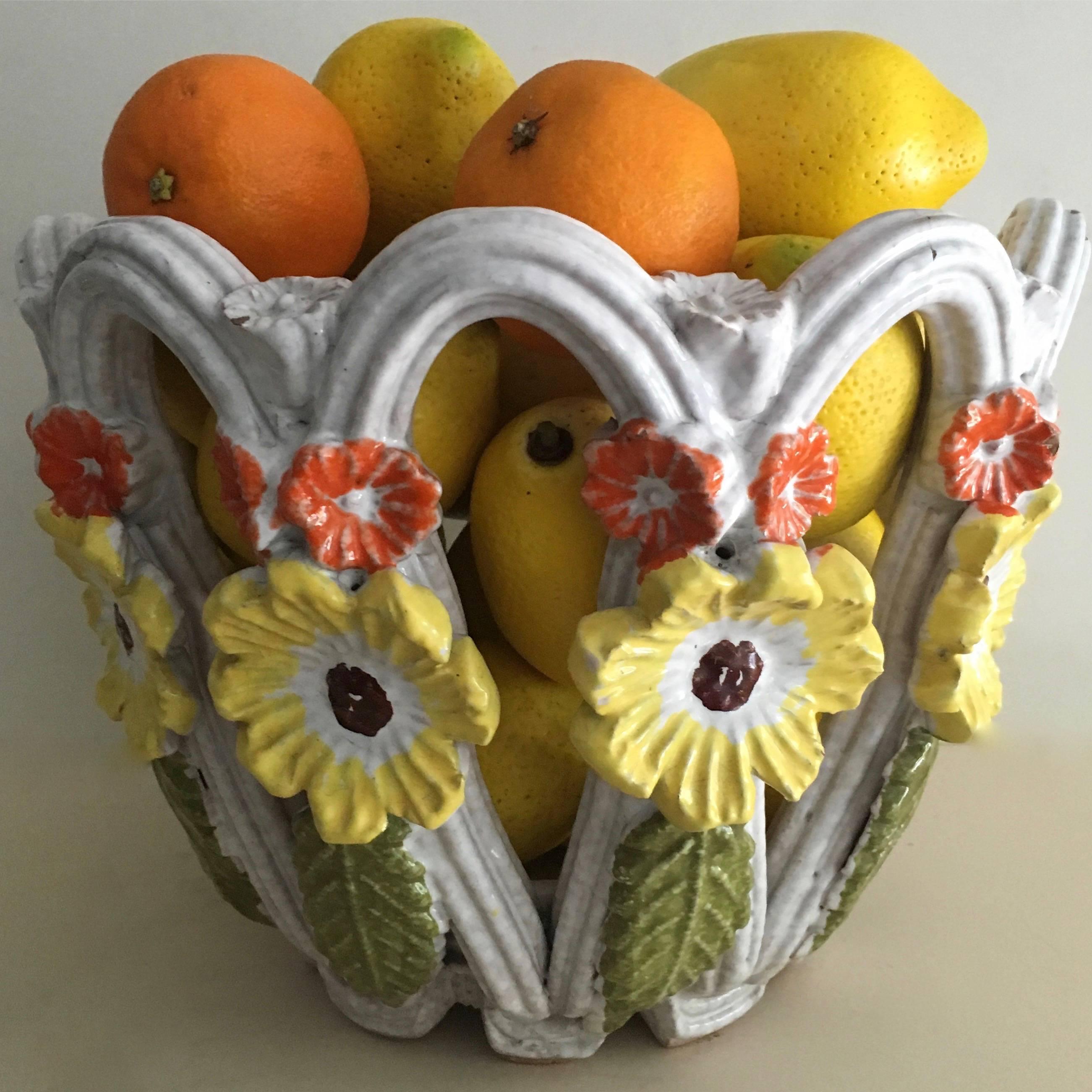 An exceptional Majolica terra cotta bowl with flower details the perfect centre piece inside or out or decorative accent to any room. The bold design and colorful flowers make this an outstanding piece. 
 