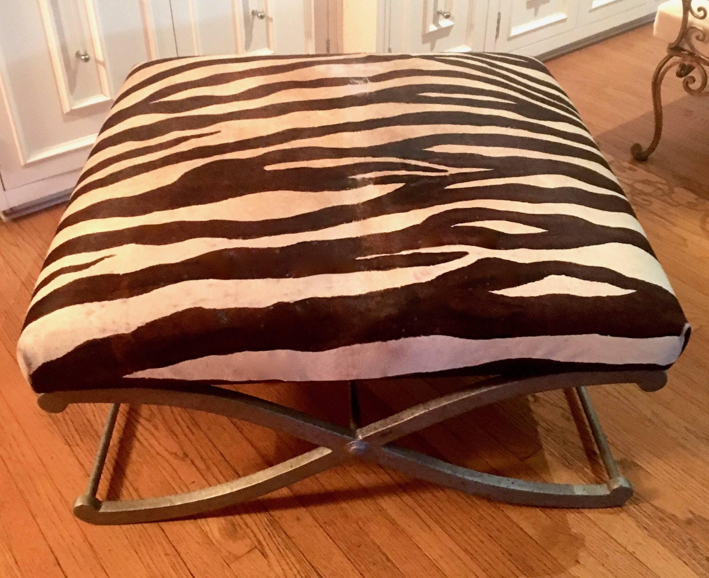 Stunning zebra ottoman bench with metal X-based legs - the piece is in excellent Vintage condition with just enough Patina it will easily relax into any living room, den or exotic bedroom.
  