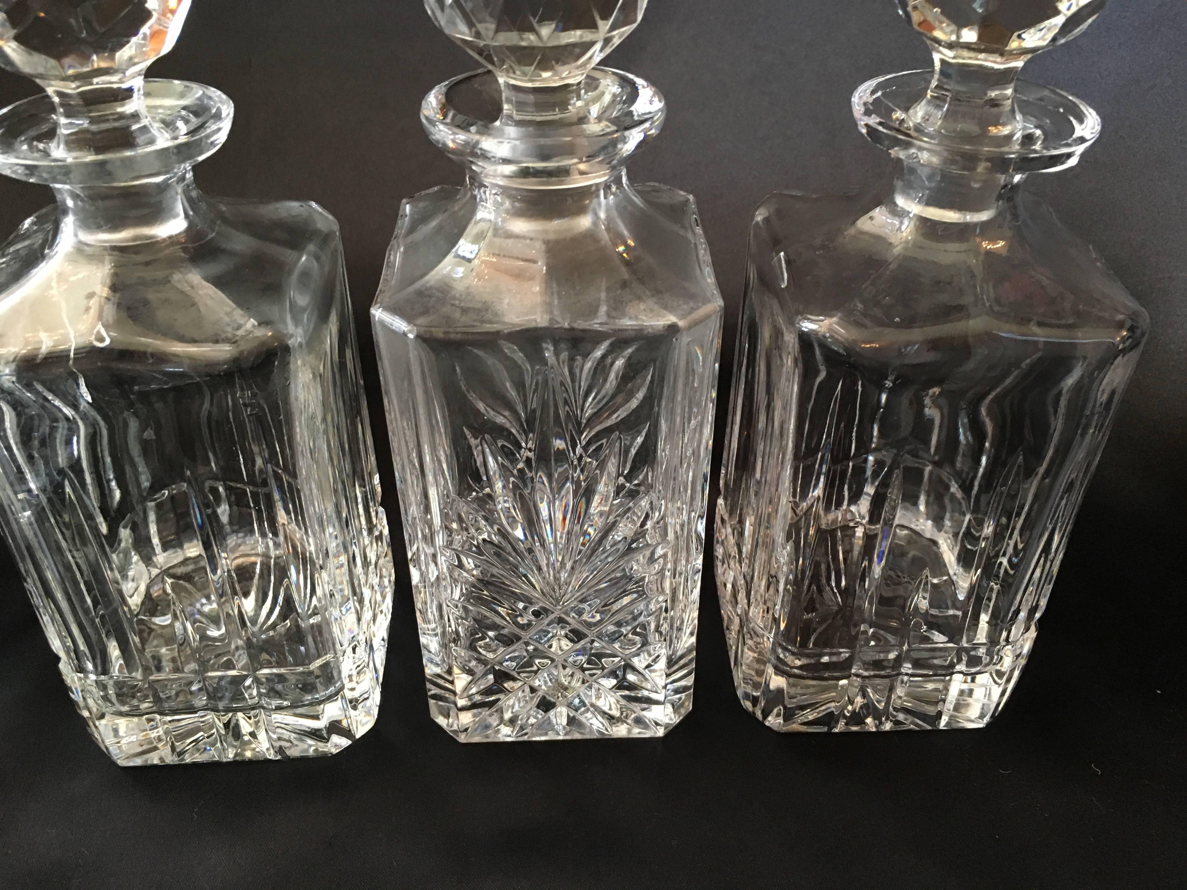 A perfect set for any bartender, the Stately English set contains six decanters. All complimentary in size and style. Two (identical) are cut lead crystal and the remaining four (identical) are glass, all with crystal, well fitted spherical stoppers