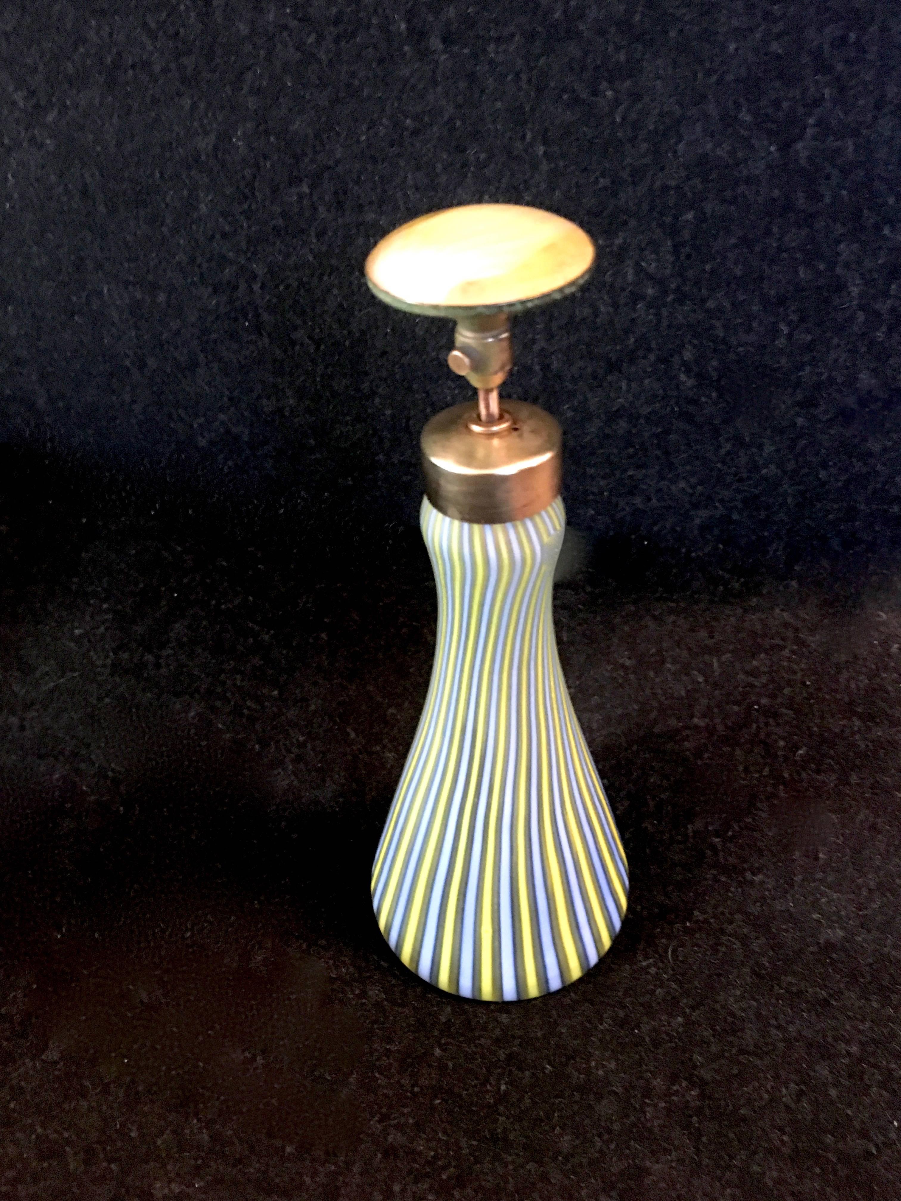 Italian Murano glass perfume bottle / atomizer

Blue / yellow blown glass Murano, colorful and ideal for the vanity or dresser.