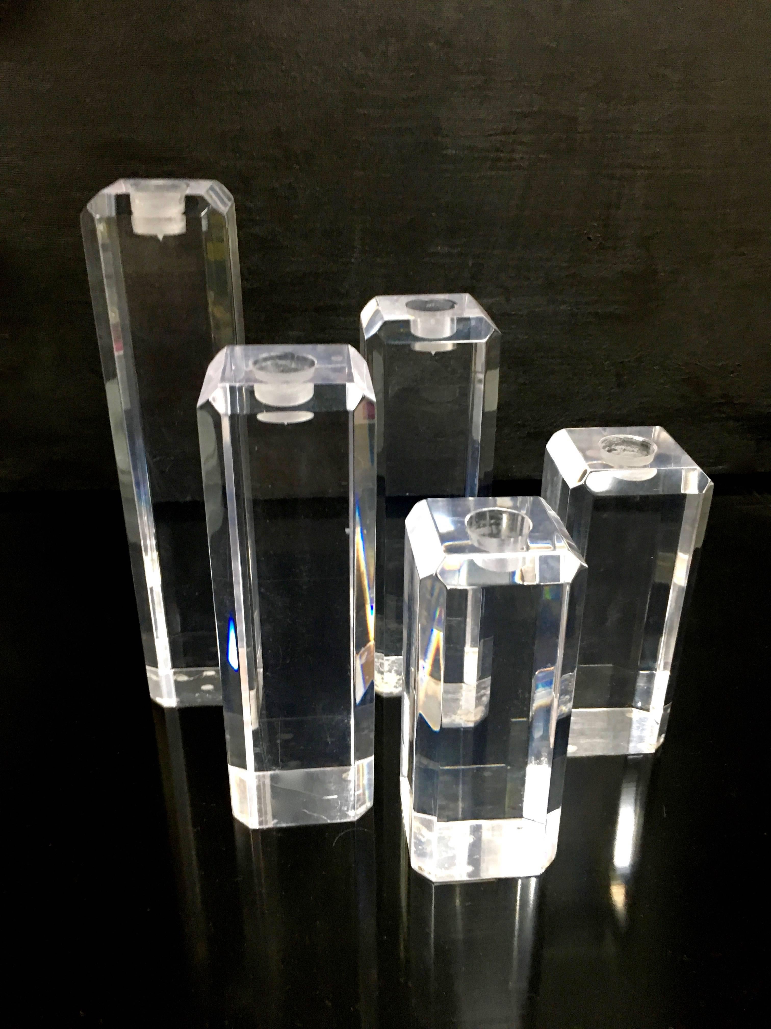 An important grouping of five Acrylic candlesticks in varying sizes - a stunning focal point for the dining table, console or outside dinner party.

All are 2.5" Square and two 6", two 8" and two 10"
