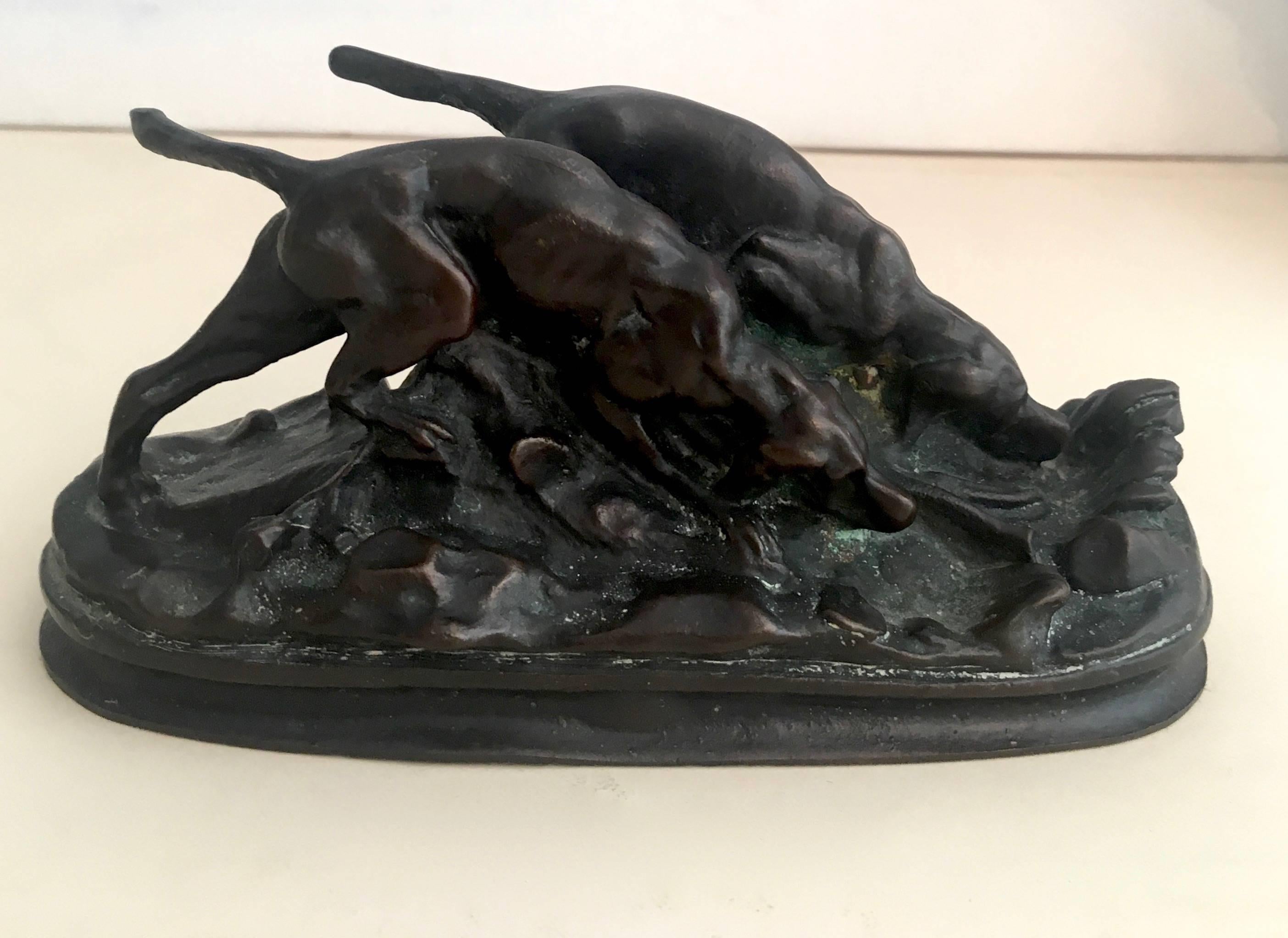 A small but important and impressive bronze sculpture of hunting Bloodhounds by renowned artist Bayre, signed.