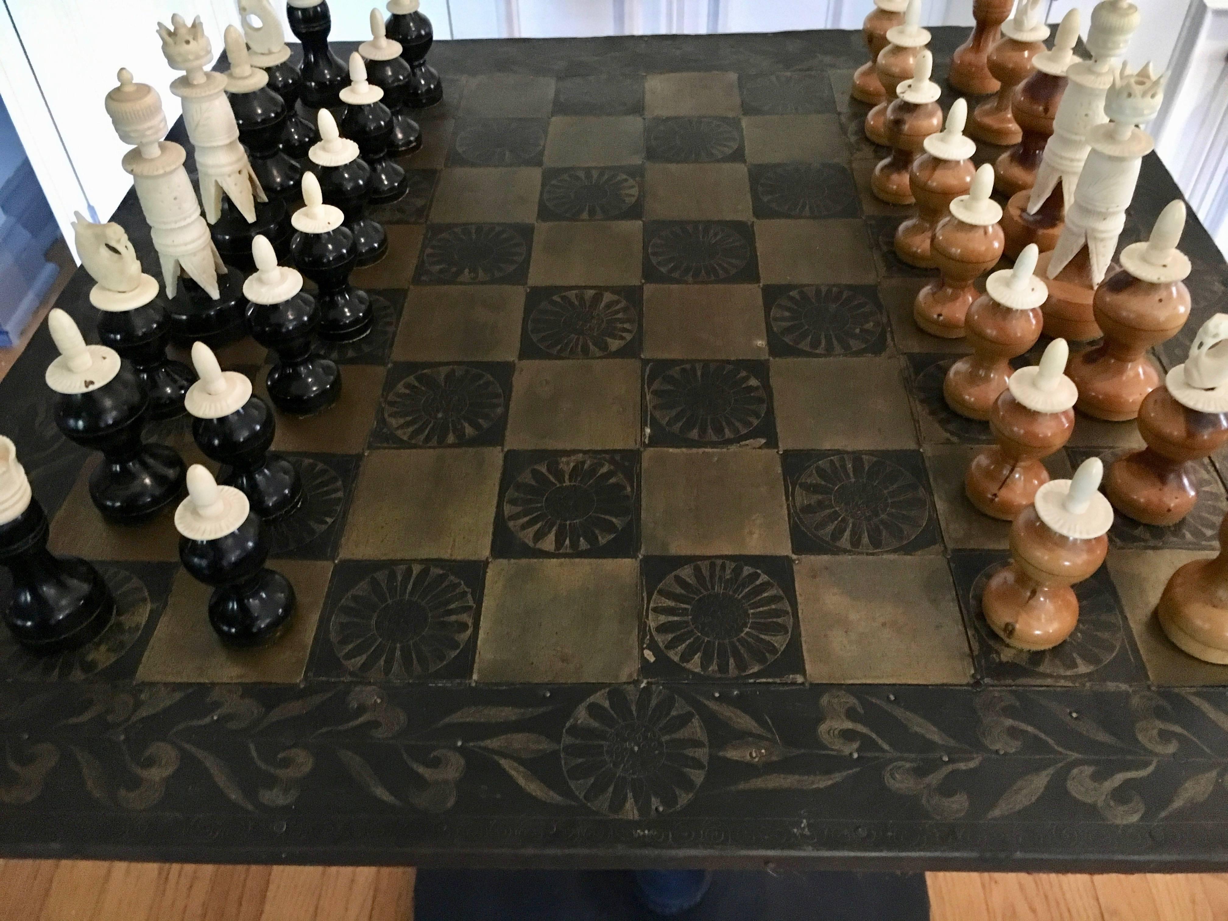 Metal Mexican chess board with hand-carved wooden chess men - the table is felt backed and can be removed to play on any surface, handmade in Mexico of hammered metal with hand-carved wooden men.