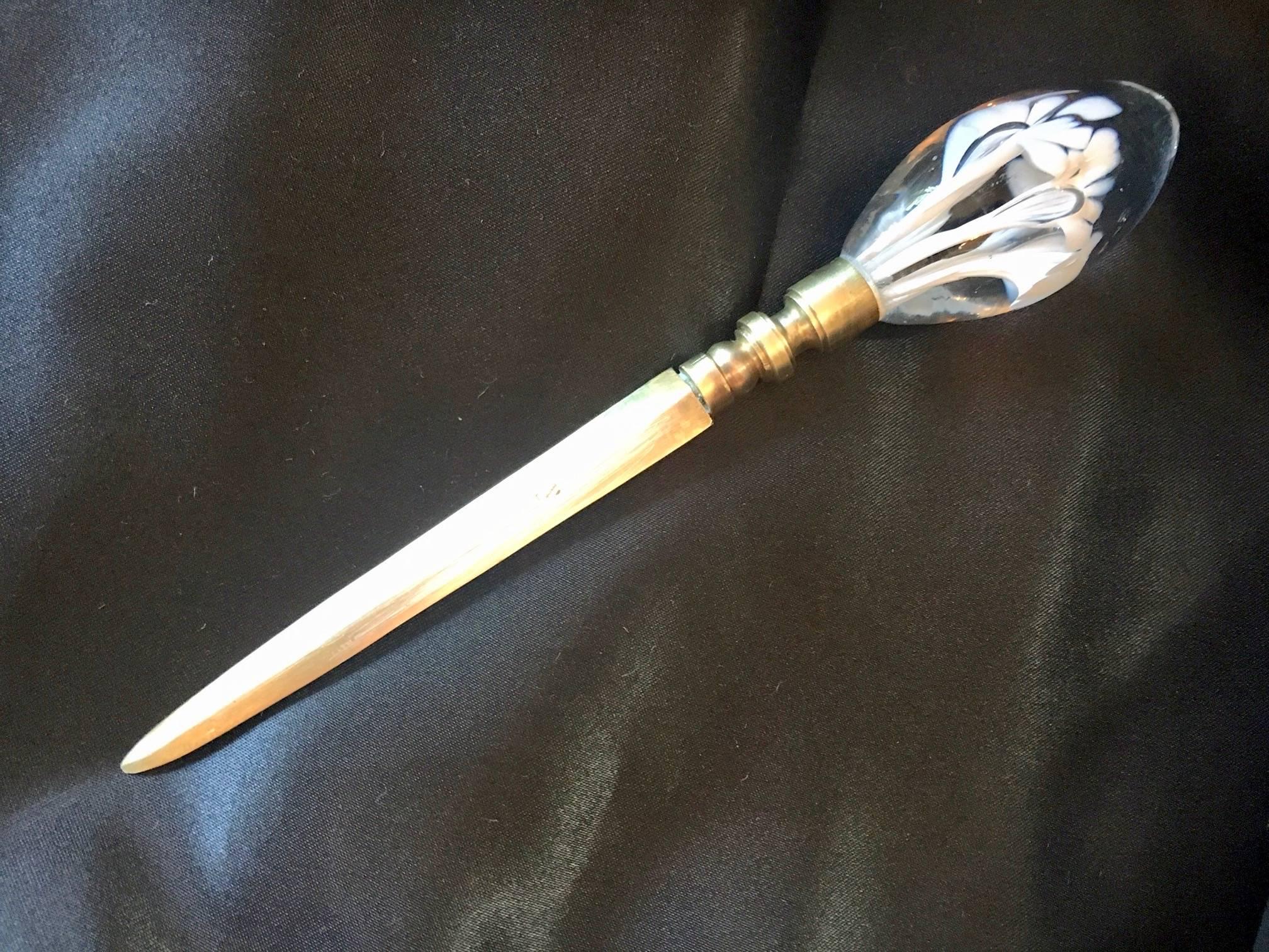 A Murano glass blown finial paired with a brass paper weight. This is a stunning and large letter opener. Perfect for opening that un-stoppable barrage of Love letters, or perhaps, the tide has shifted and those love letters are own Divorce papers?