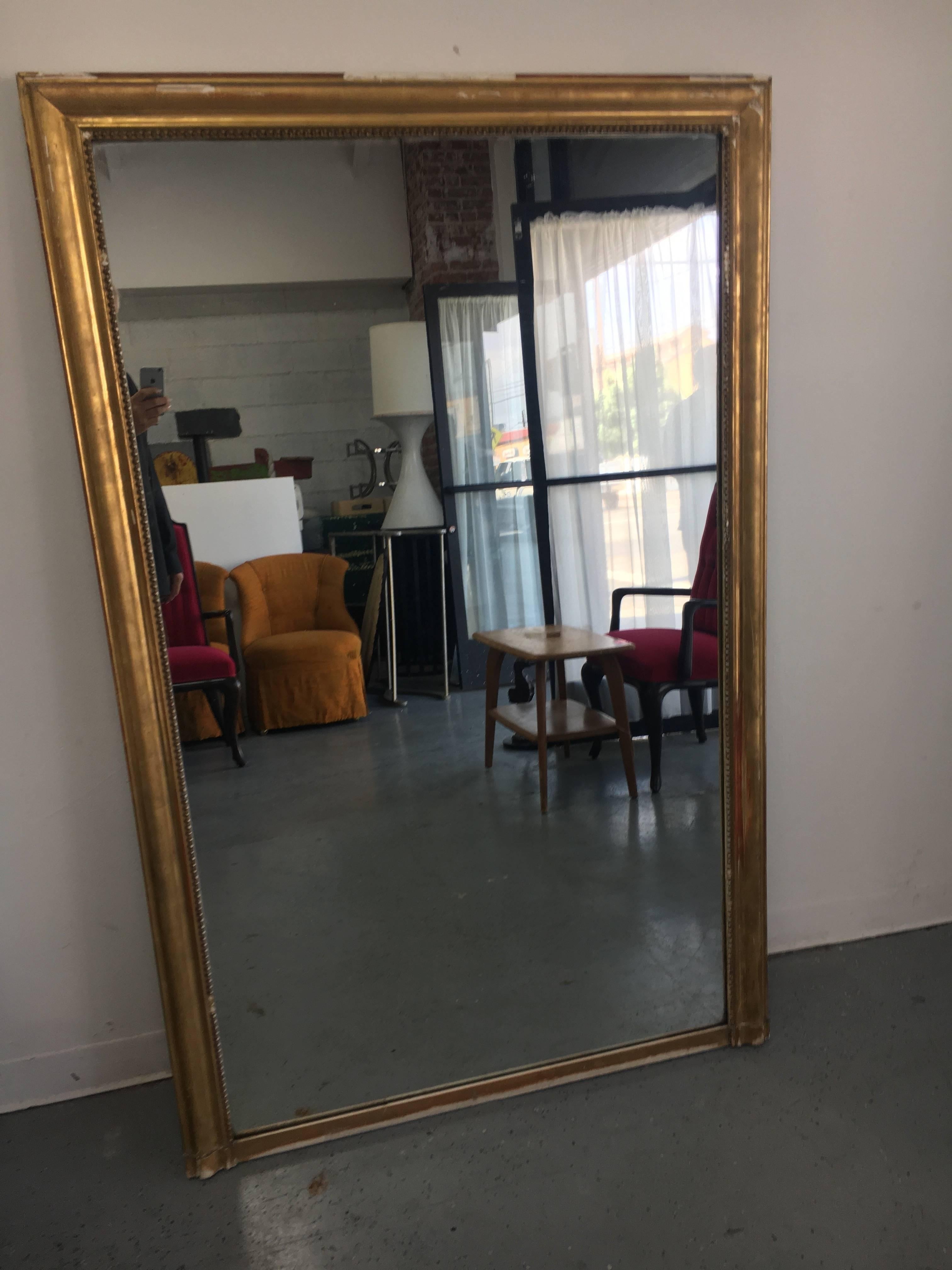 French gilt mirror. A beautiful example of time, in conjunction with age, and heritage, give this piece a fantastic look and patina. Losses around the perimeter only add to the years of character.

The mirror can hang on the wall or perhaps use