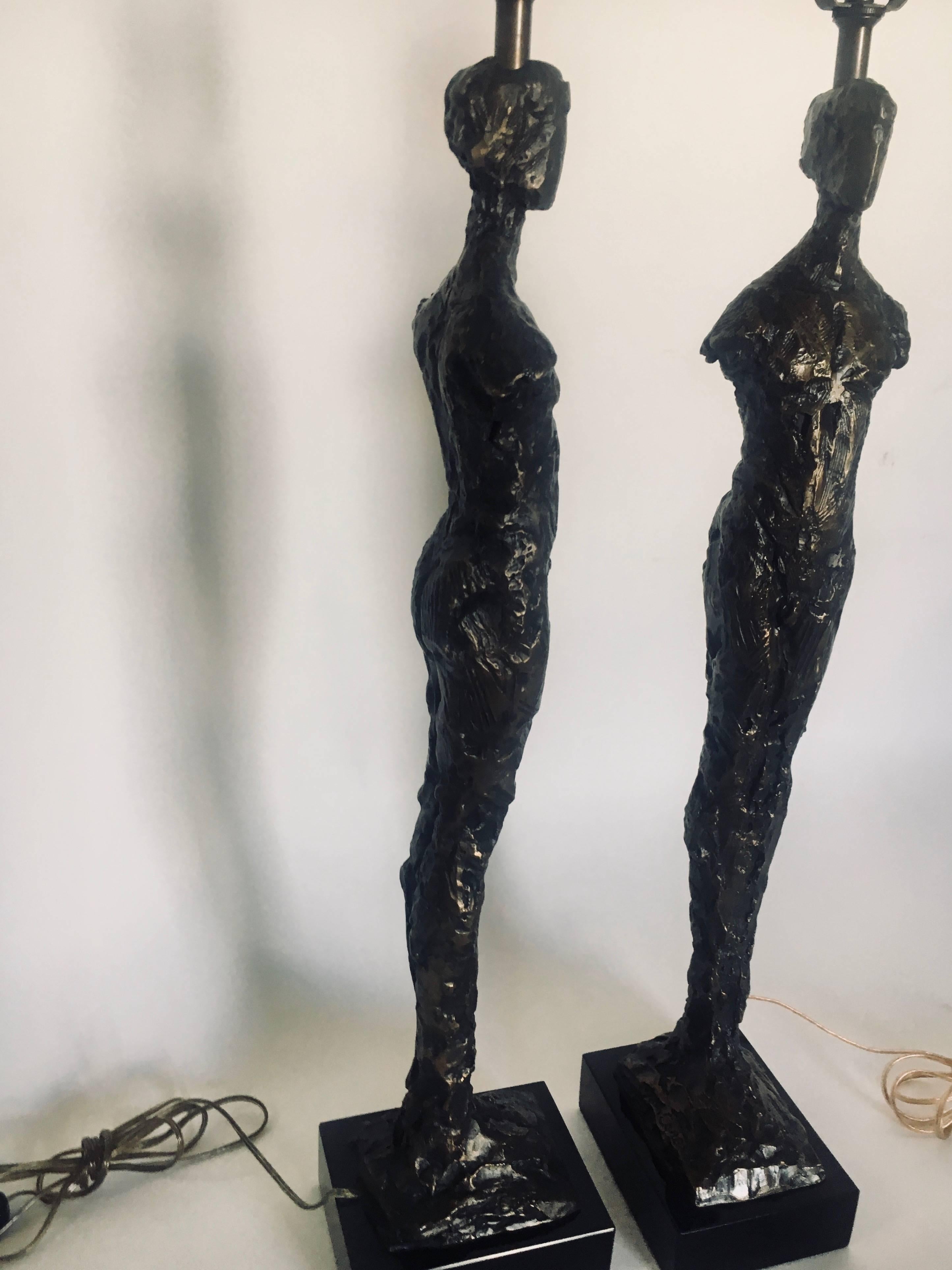 Pair of Tom Corbin bronze Adam lamps with bronze finials. A stunning pair for any room signed by the artist. Strongly reminiscent of Diego Giacometti.