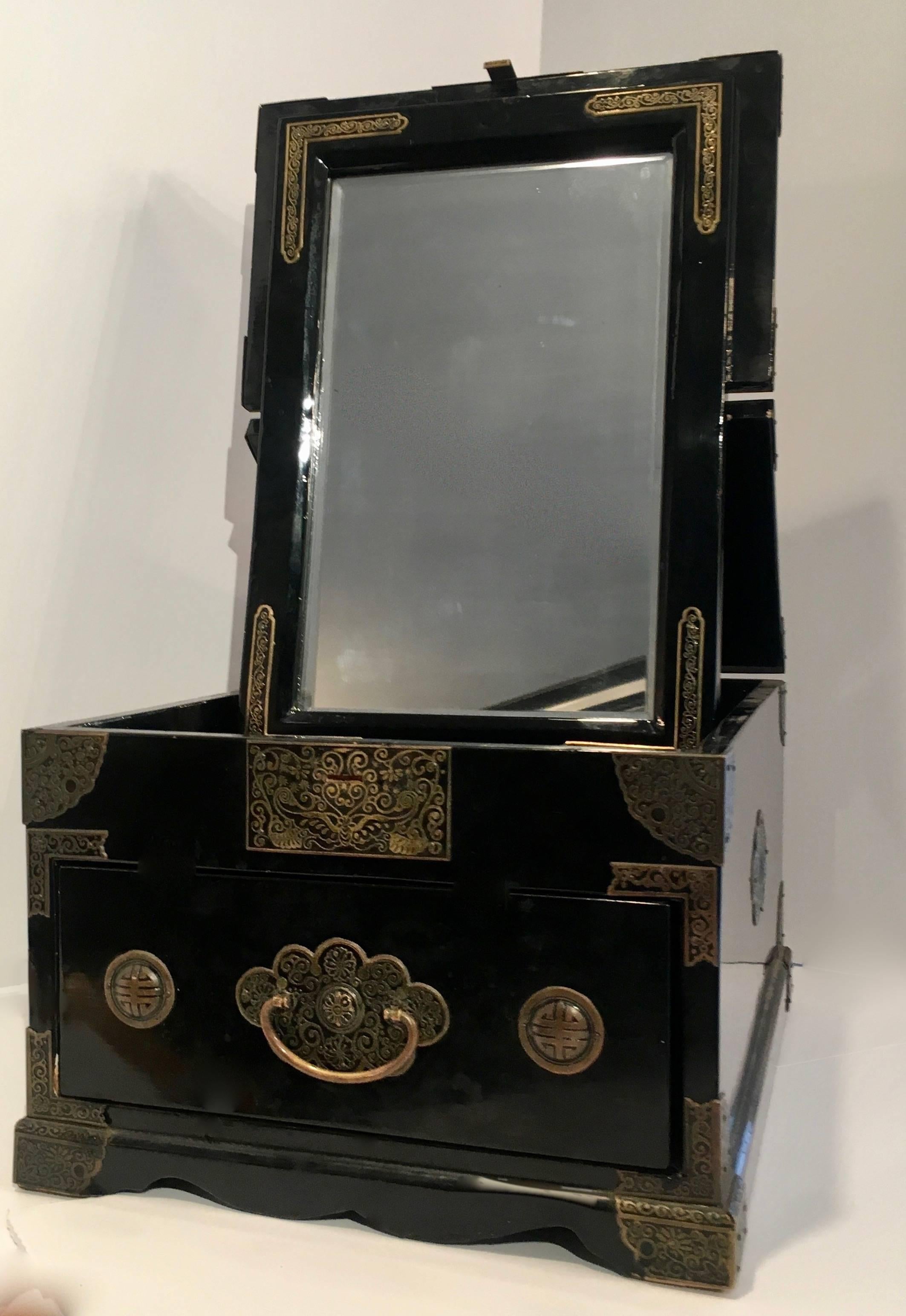 Chinese black lacquer makeup box / cosmetic chest with mirror. A lovely addition to the dressing table or ladies closet - the black lacquer box folds down or can be opened to reveal mirror - the box is intricately designed with brass details and one