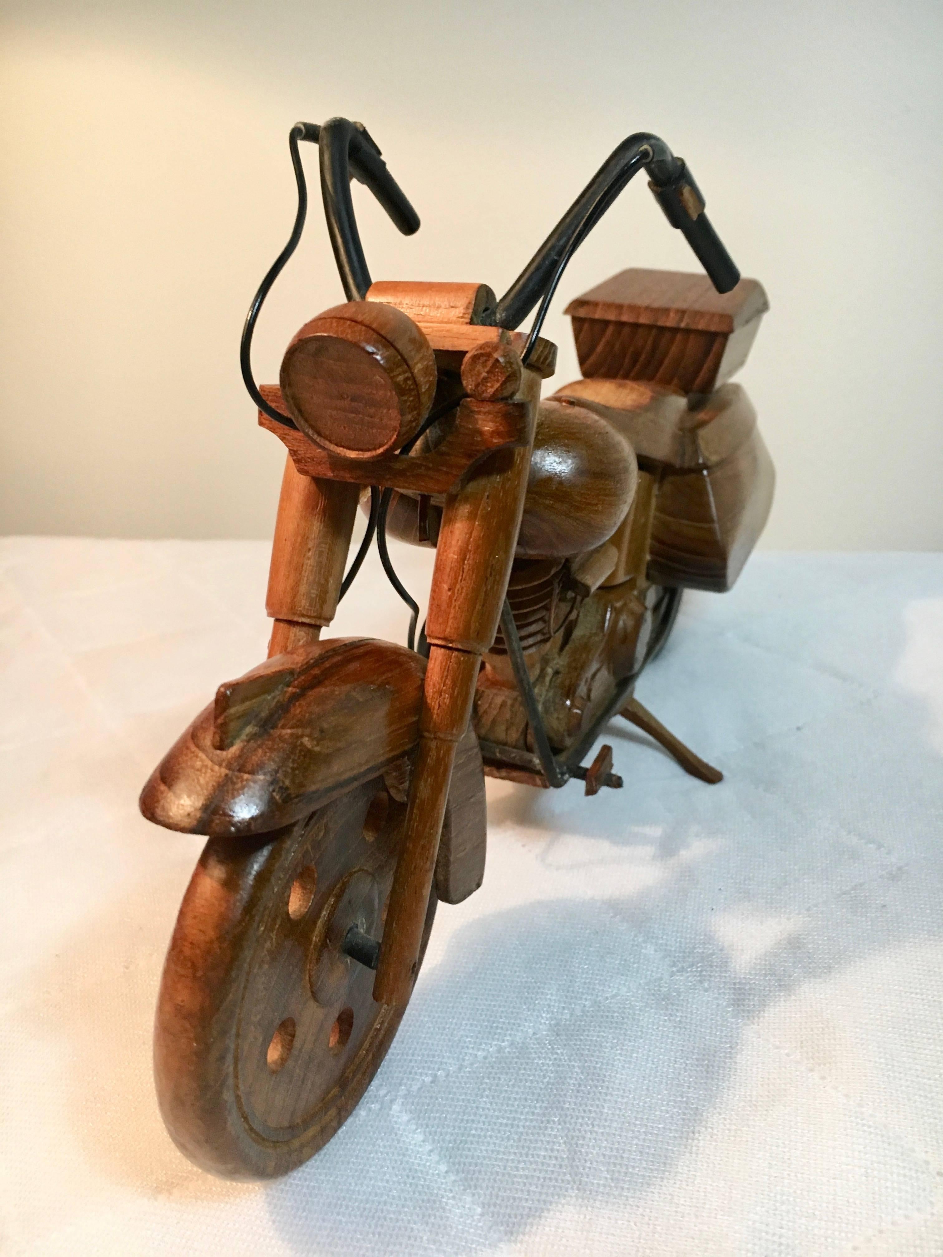 Very detailed wooden sculpture / replica of a motorcycle - Wheels turn and kick Stand functions allowing the bike to Stand in place.
This piece is ideal for the motorcycle enthusiast, office or den - Childs room. a very thoroughly thought out model.